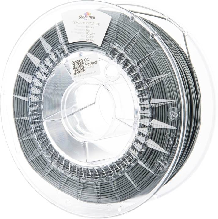 Une bobine transparente de filament d'imprimante 3D gris. L'étiquette indique la marque 'Spectrum', le matériau 'PETG', la couleur 'Graphite'.