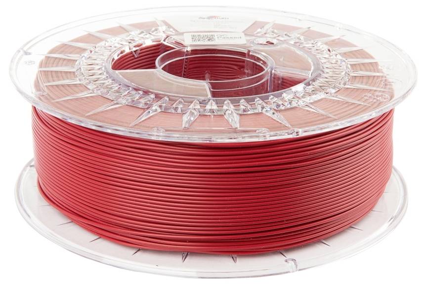 Bobine de filament rouge pour imprimante 3D, présentée sur un support en plastique transparent, vue de côté.