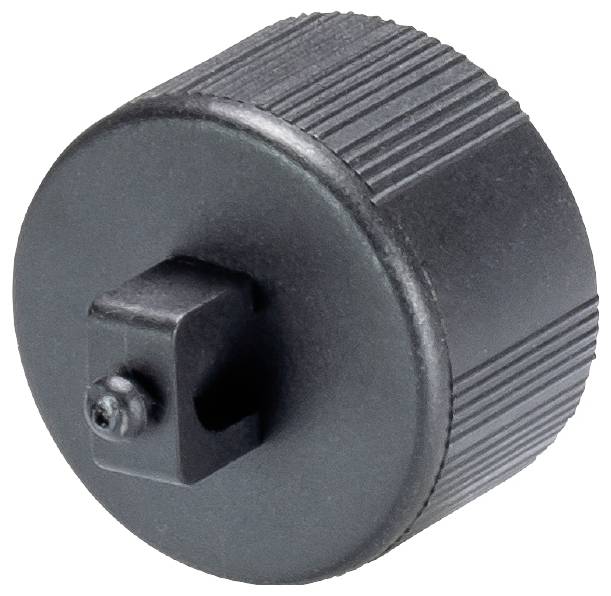 Bouton de commande noir avec côtés striés, probablement un élément d'un dispositif mécanique pour un réglage ou un contrôle manuel.