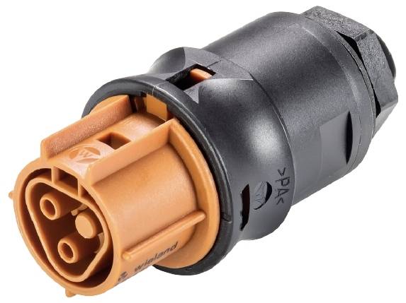 Une fiche électronique orange et noire avec plusieurs connexions rondes, adaptée aux branchements dans les appareils électriques.