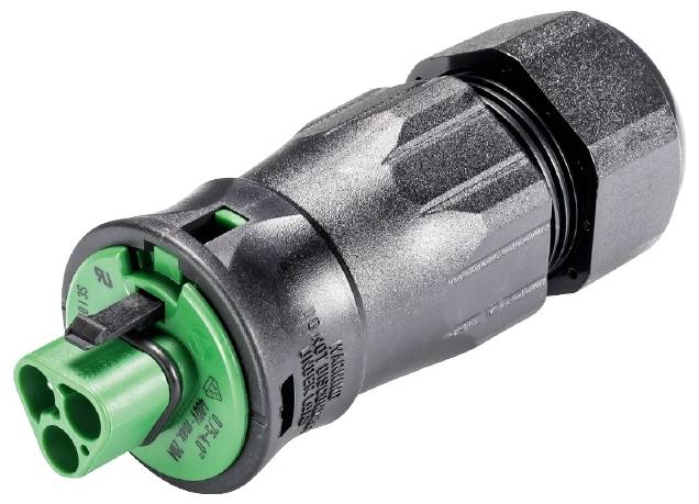 Un connecteur électrique noir et vert avec trois trous, utilisé pour des connexions sécurisées dans les installations électriques.