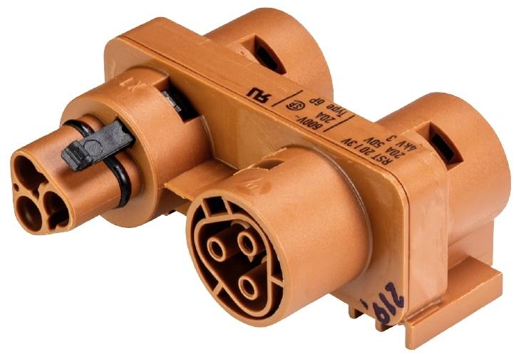 Un connecteur électrique orange avec plusieurs fiches rondes et des marquages. Adapté pour des applications techniques.