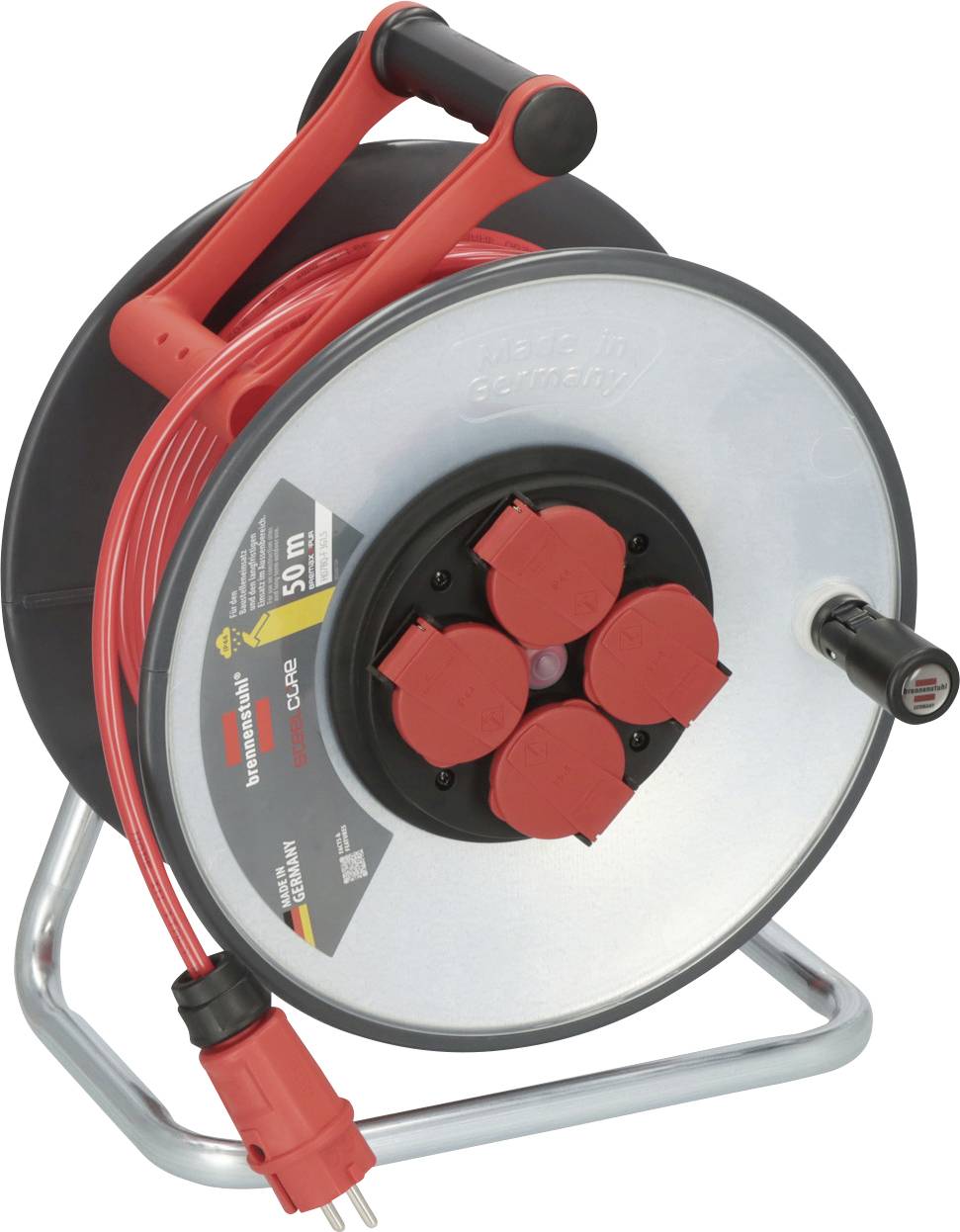 Dévidoir de câble portable sur un support métallique avec câble de rallonge rouge et plusieurs couvercles de prise rouge, utilisé pour la distribution d'électricité.