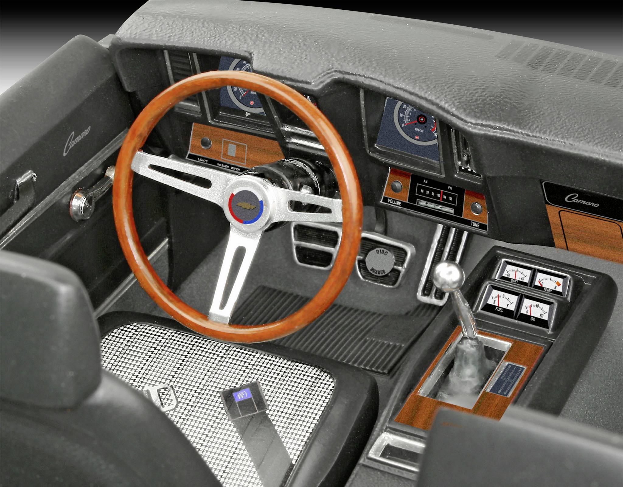 Intérieur d'une voiture classique avec volant en bois, levier de vitesses et tableau de bord doté de cadrans analogiques et de boutons.