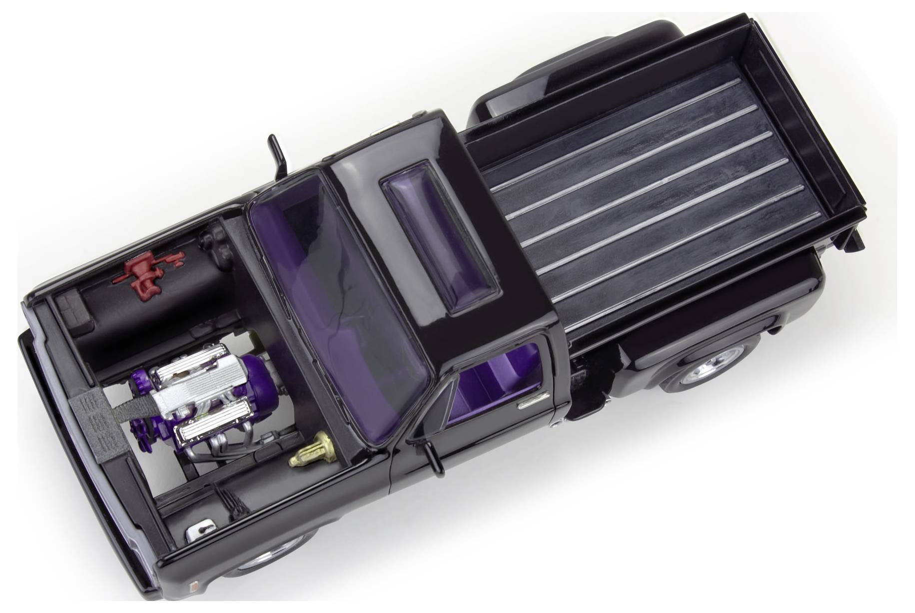 Modèle d'un camion pickup noir avec moteur et surface de chargement visibles. Vue de dessus, montrant les détails techniques et la construction.