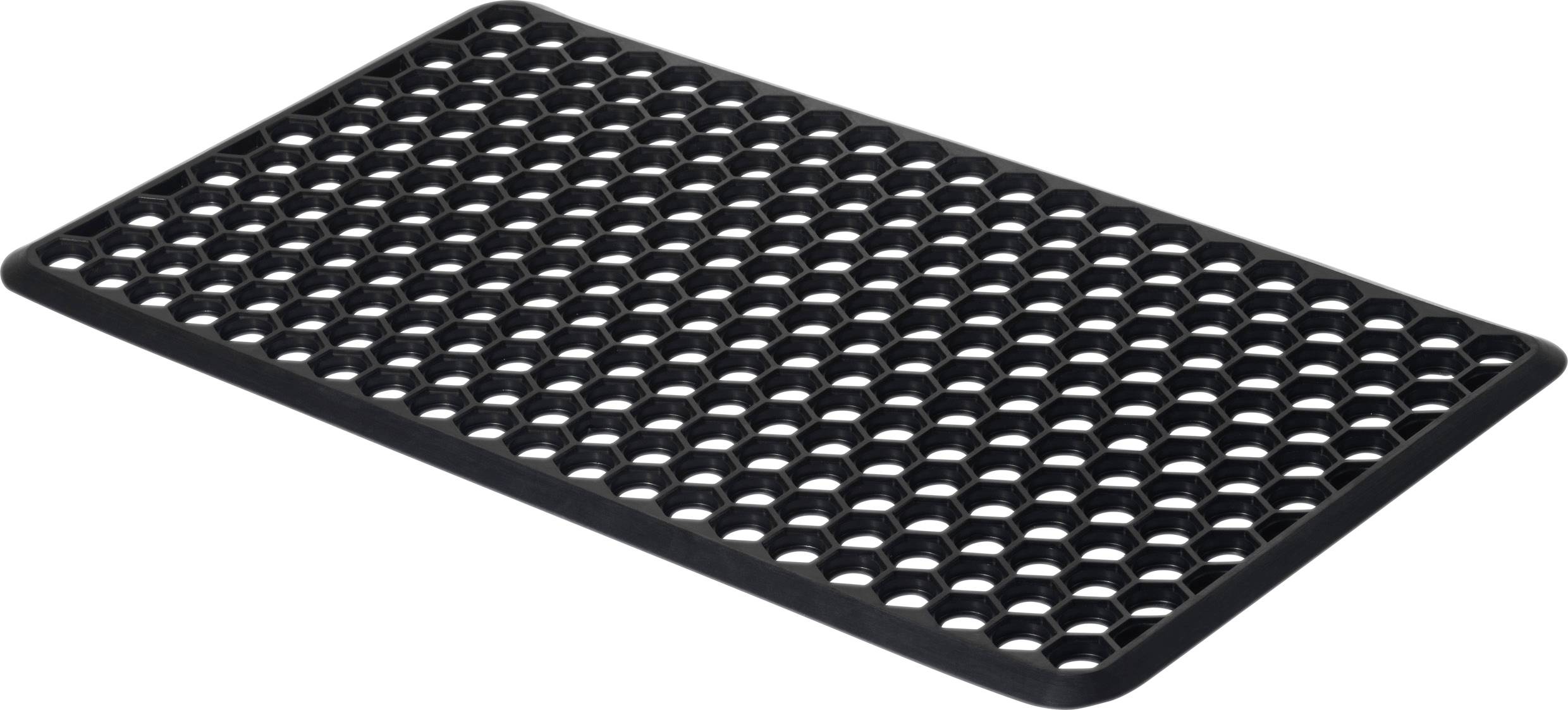Tapis en caoutchouc noir avec découpes hexagonales. Sert de surface antidérapante pour les entrées ou les espaces de travail.