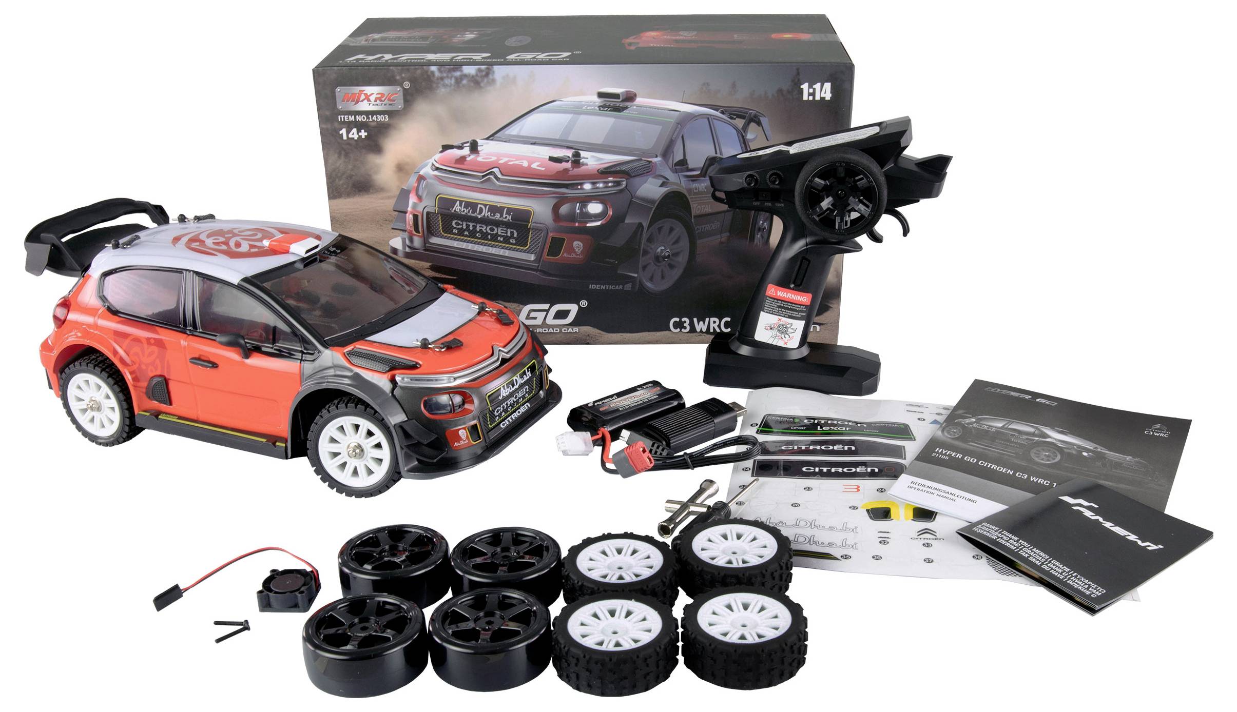 Voiture télécommandée de style rallye, rouge et blanc, avec accessoires comprenant une télécommande, des pneus de rechange et un manuel. L'emballage présente une image du véhicule.