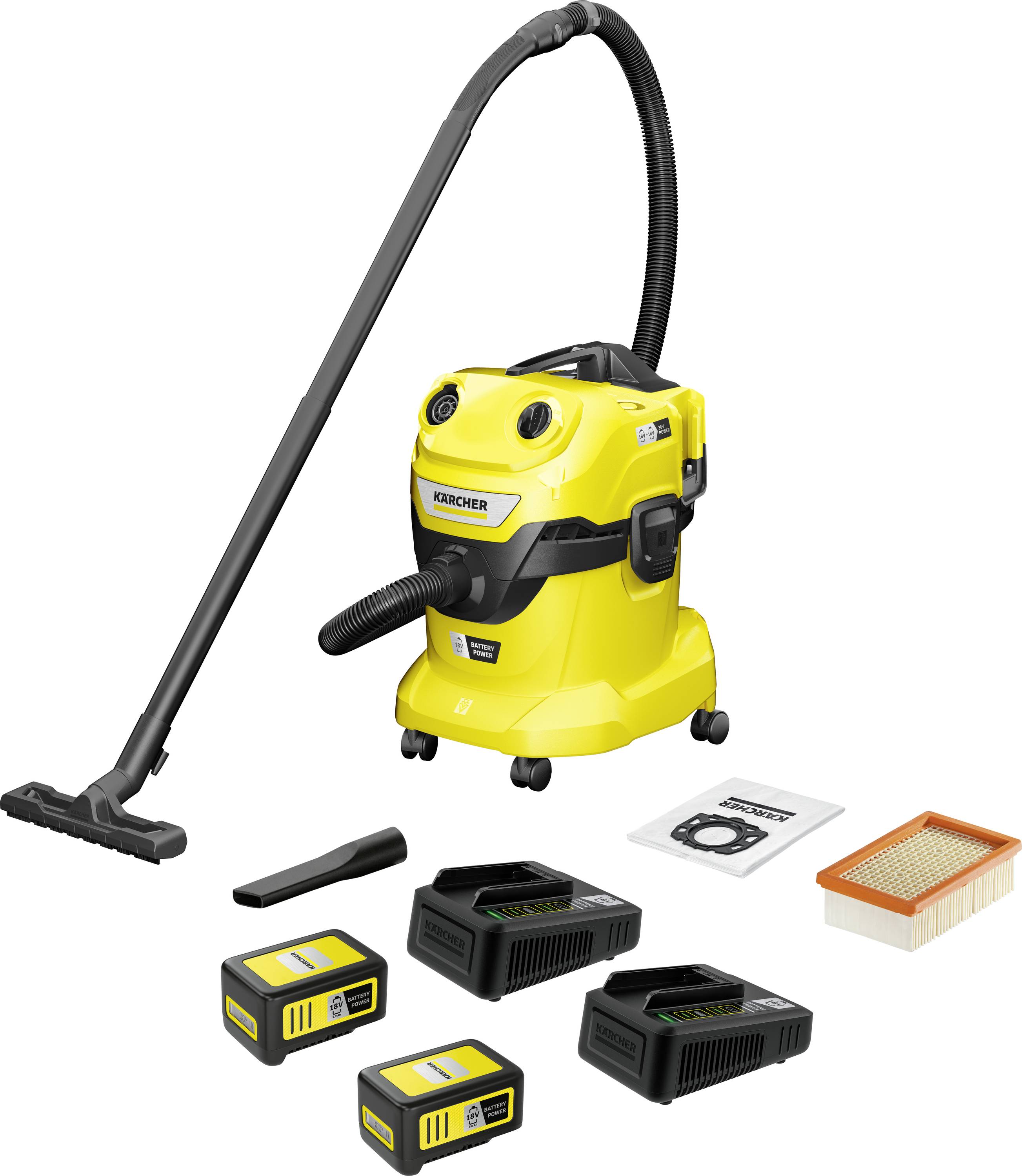 Aspirateur industriel jaune avec accessoires : deux batteries, deux chargeurs, filtre et sacs, prêt pour des travaux de nettoyage.