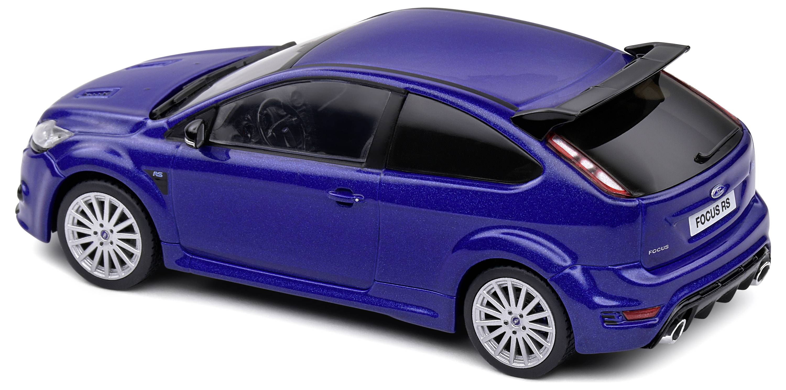 Voiture miniature bleue d'une compacte sportive, équipée d'un aileron arrière imposant et de jantes argentées, photographiée en vue trois-quarts arrière.