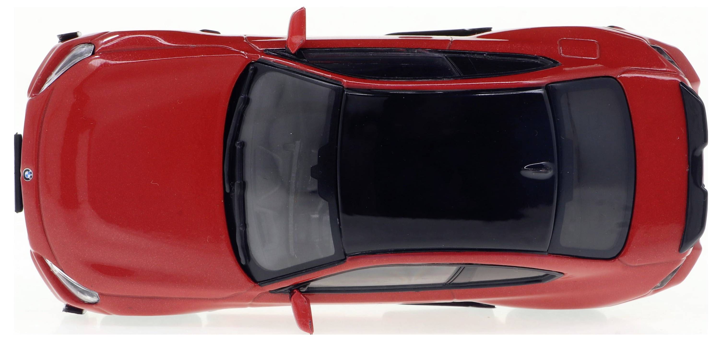 Voiture rouge vue de dessus, avec toit et rétroviseurs noirs.