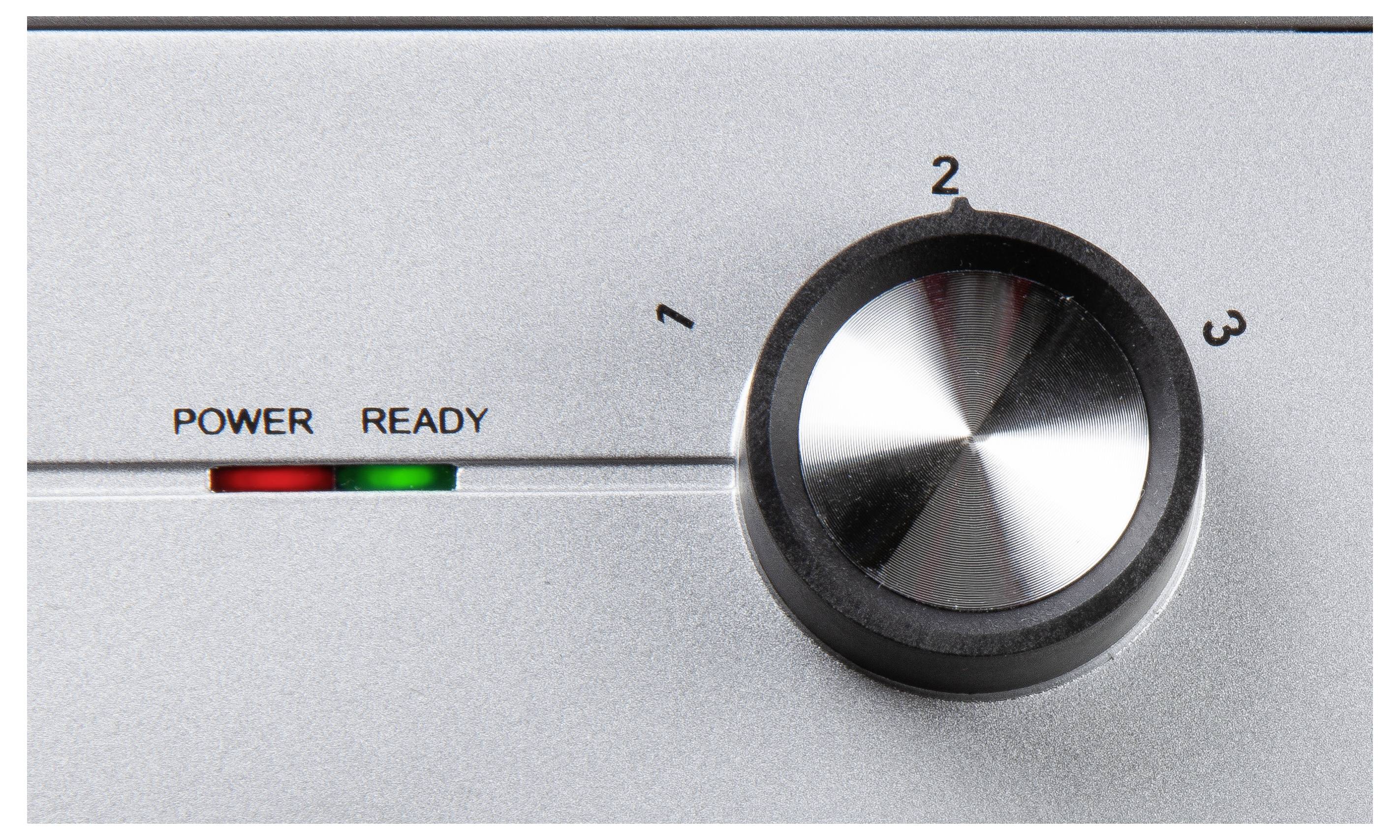 Un appareil argenté avec un bouton rotatif réglé sur le niveau 2. Des voyants lumineux indiquent 'Power' en rouge et 'Ready' en vert.