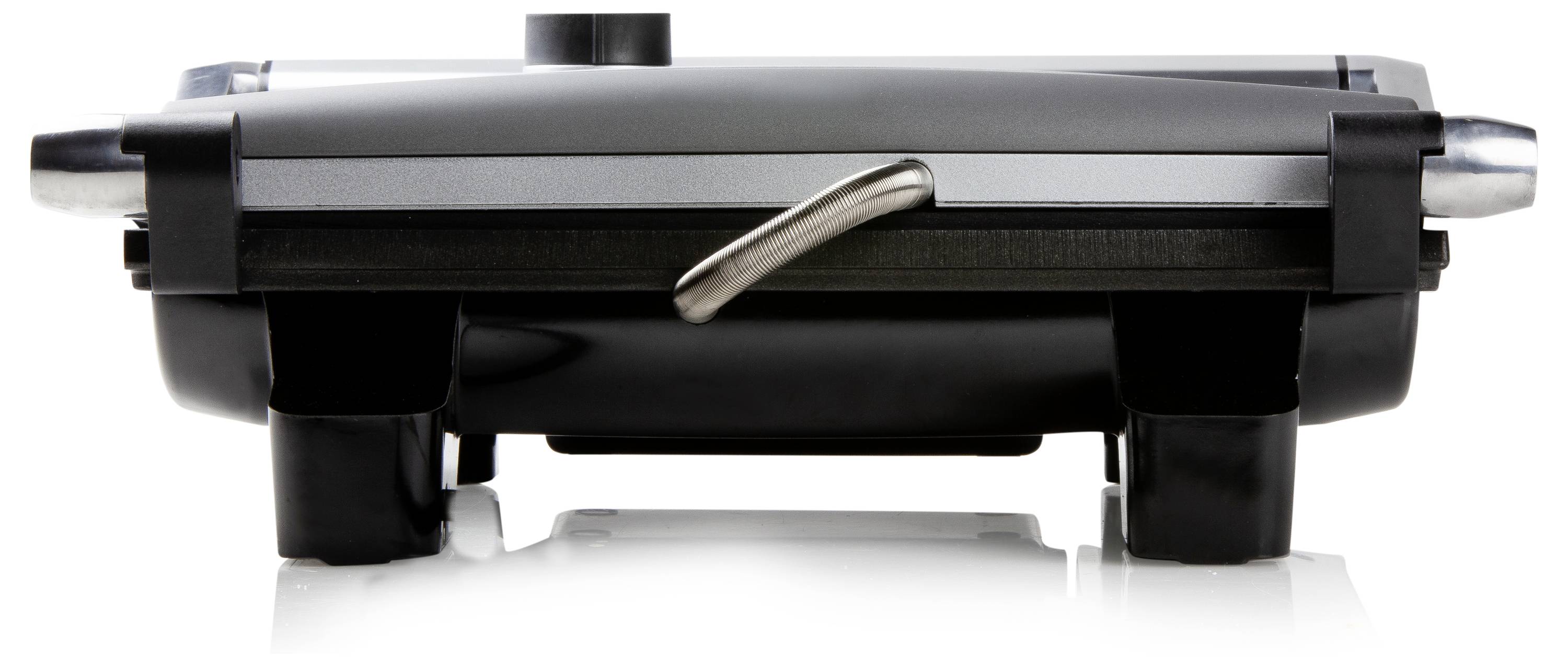 Grille-pain en acier inoxydable, vu de côté sur une surface réfléchissante.