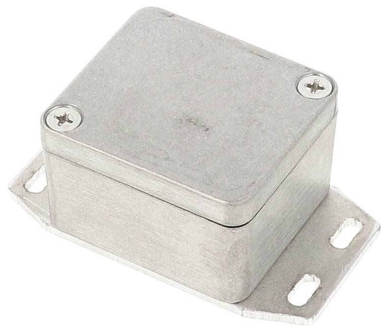 Boîtier métallique, rectangulaire avec des coins arrondis, fixé par des vis aux angles sur une platine de montage plate.