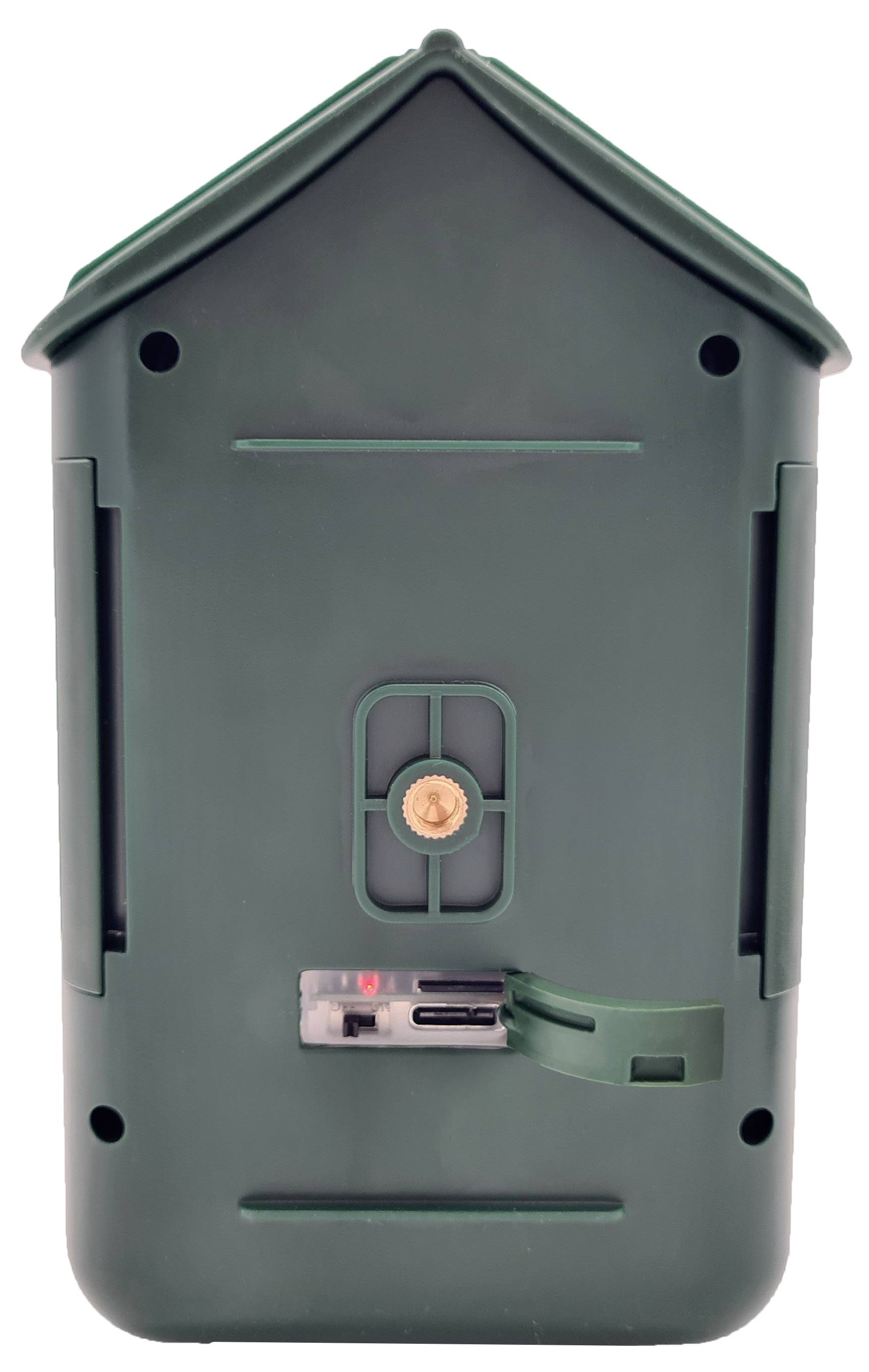 Une protection en plastique vert rectangulaire avec une petite trappe au centre, probablement destinée aux batteries ou aux connexions.