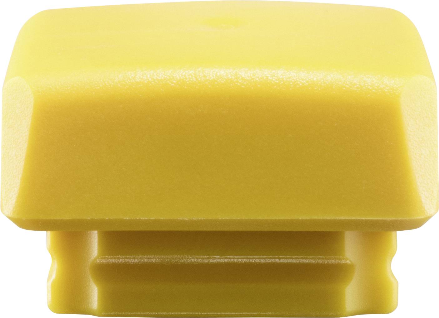 Couvercle en plastique jaune rectangulaire, photographié depuis le dessous, montrant sa forme et sa structure.