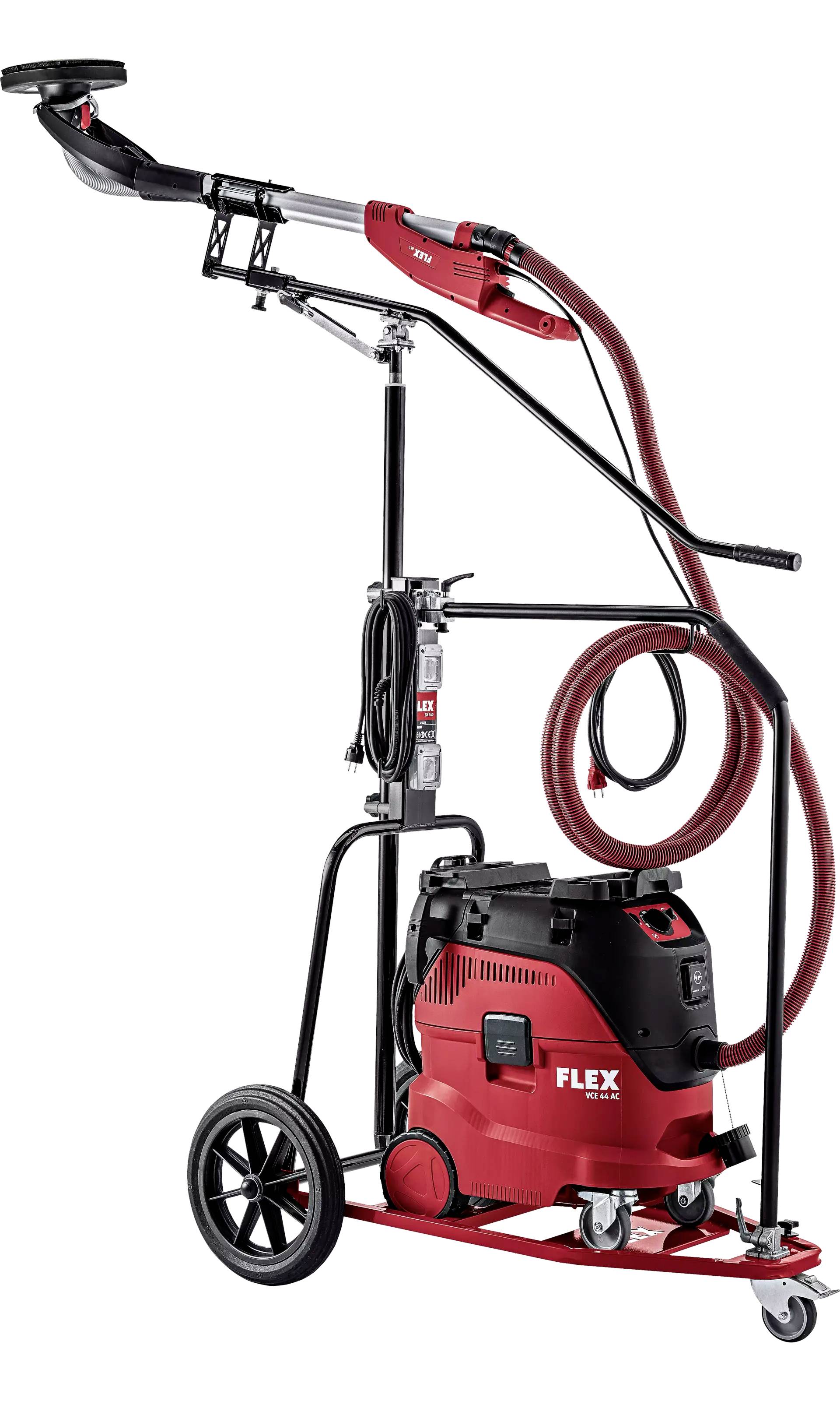 Système de ponçage rouge sur roues avec aspirateur et longs tuyaux, adapté aux grandes surfaces dans les projets de construction ou de rénovation.