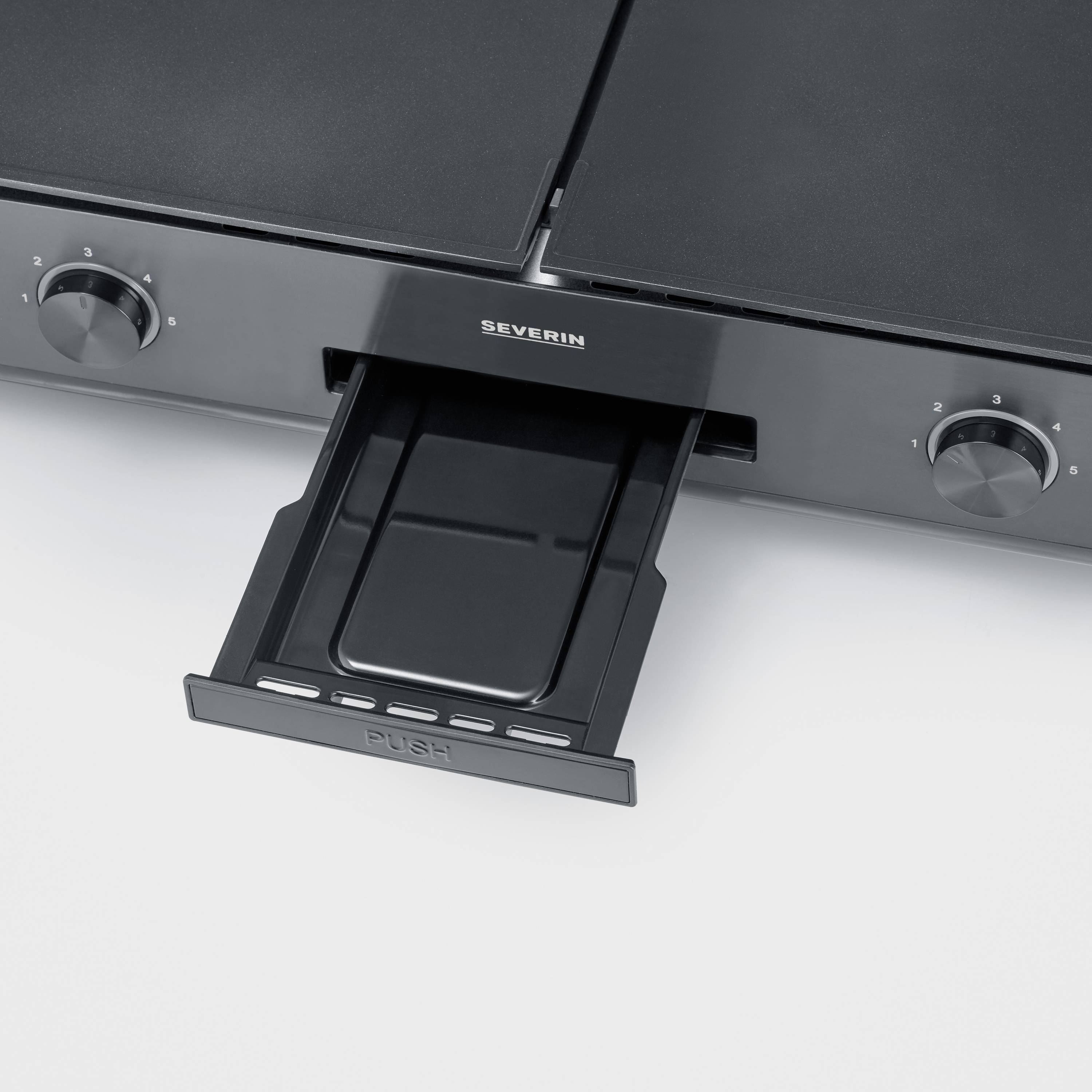 Plaque de cuisson à deux plaques avec tiroir rabattable. Éléments de commande avec échelles de 0 à 3 sur chaque plaque.