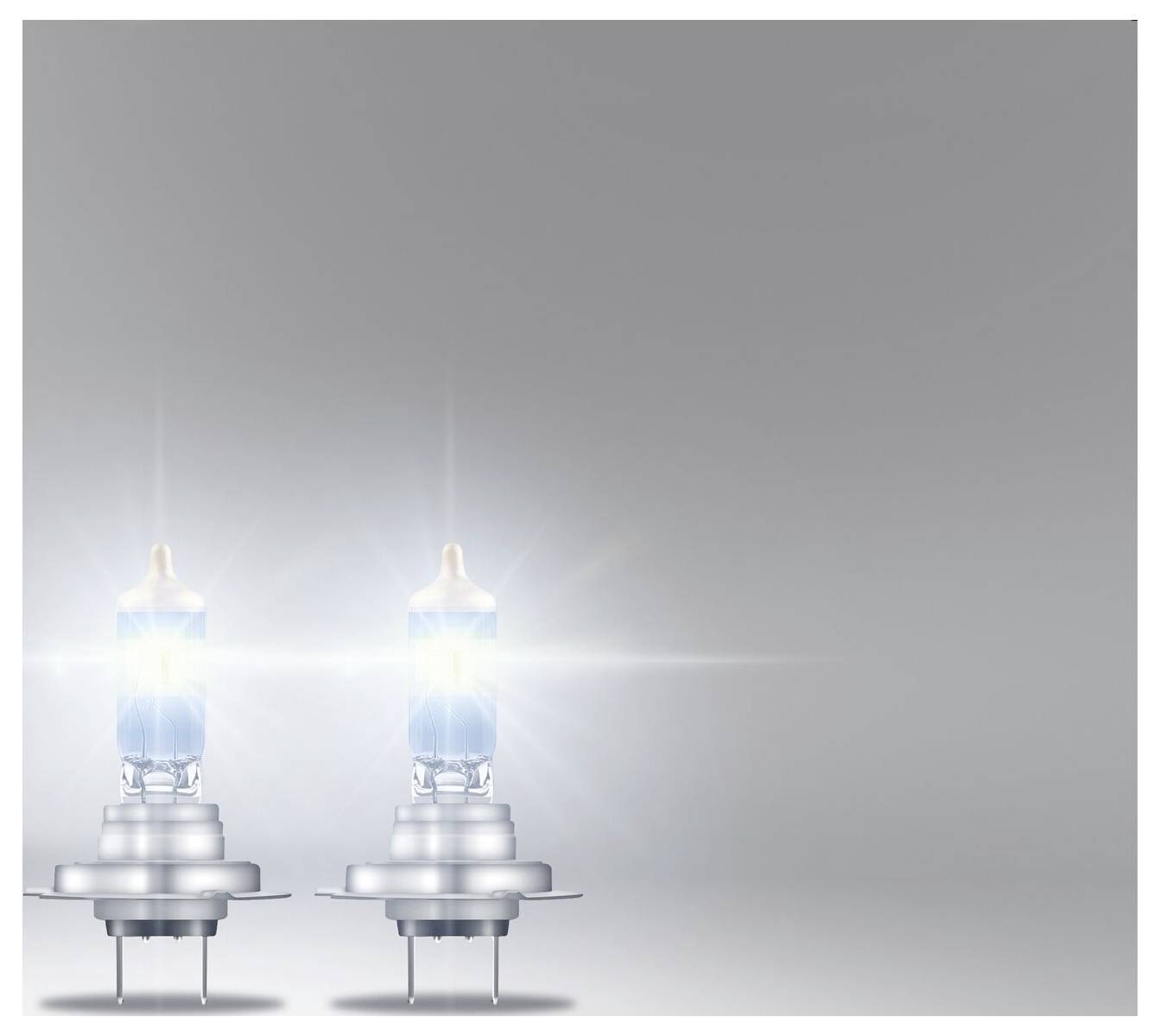Deux ampoules lumineuses placées à gauche au premier plan sur un fond gris. Les ampoules émettent une lumière intense.