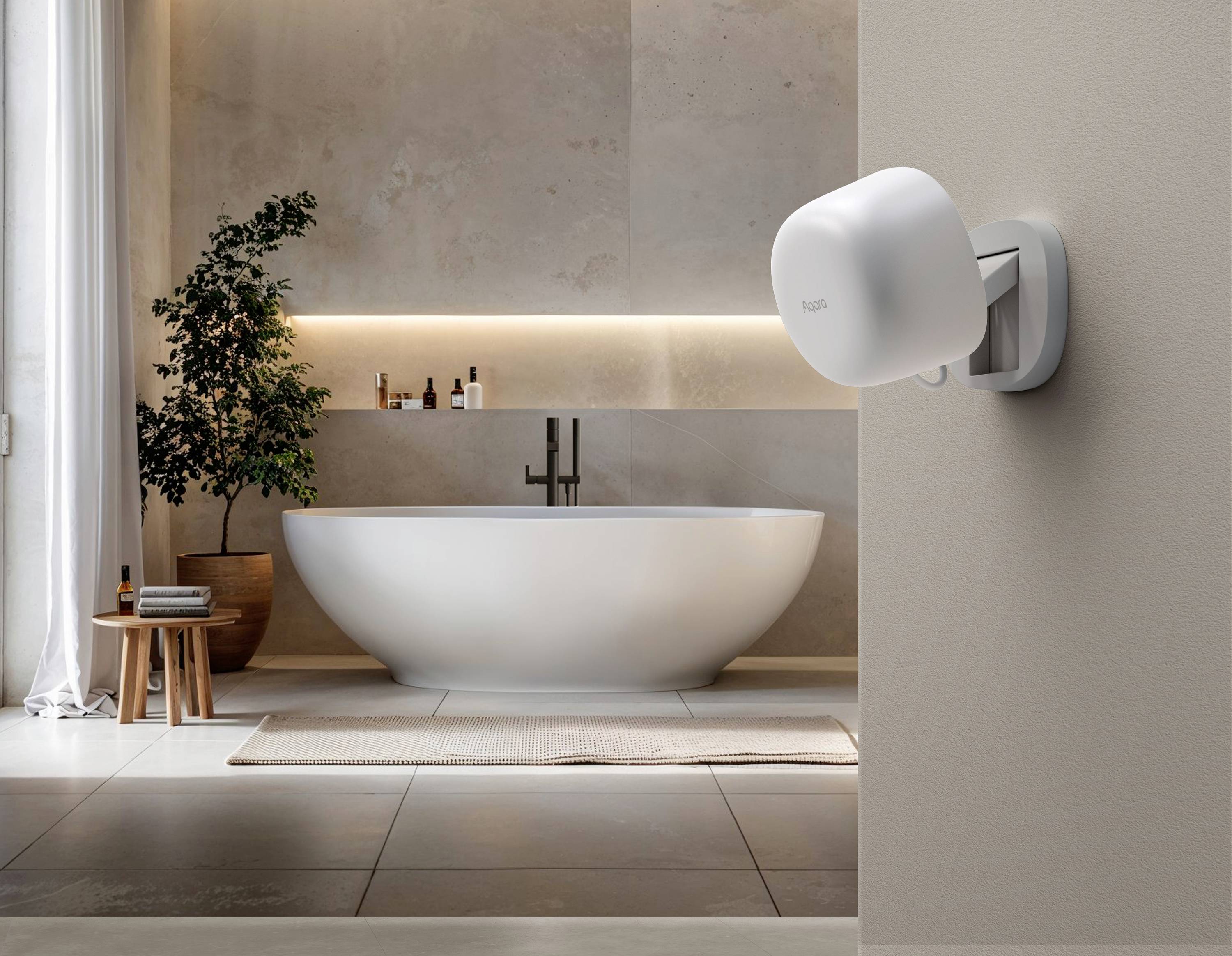 Baignoire îlot dans une salle de bain moderne avec étagère murale et éclairage ; au premier plan, un routeur Wi-Fi fixé au mur.