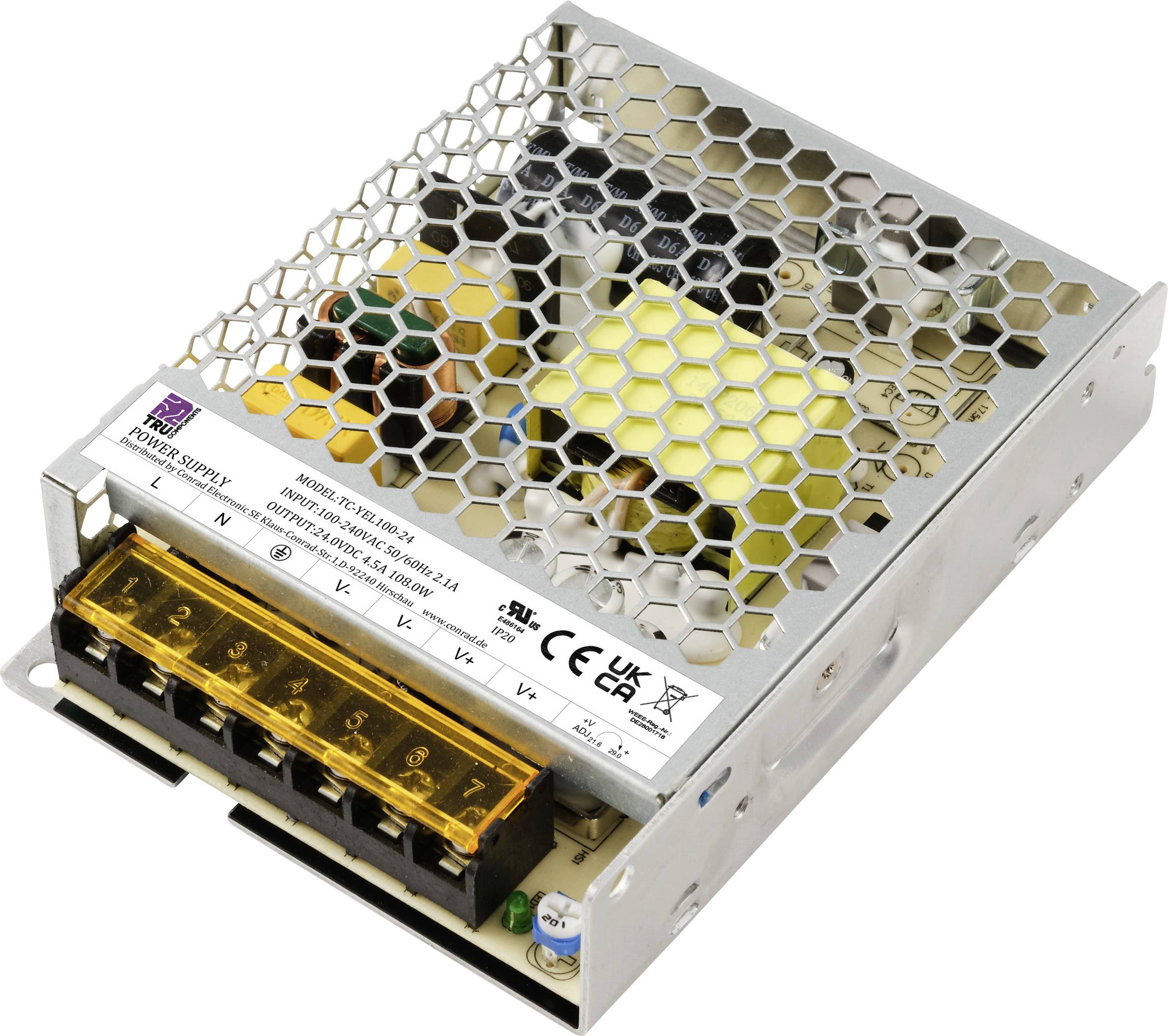 Un bloc d'alimentation à découpage de couleur argentée avec un couvercle à structure alvéolée et un bornier jaune, avec différents composants électroniques visibles.