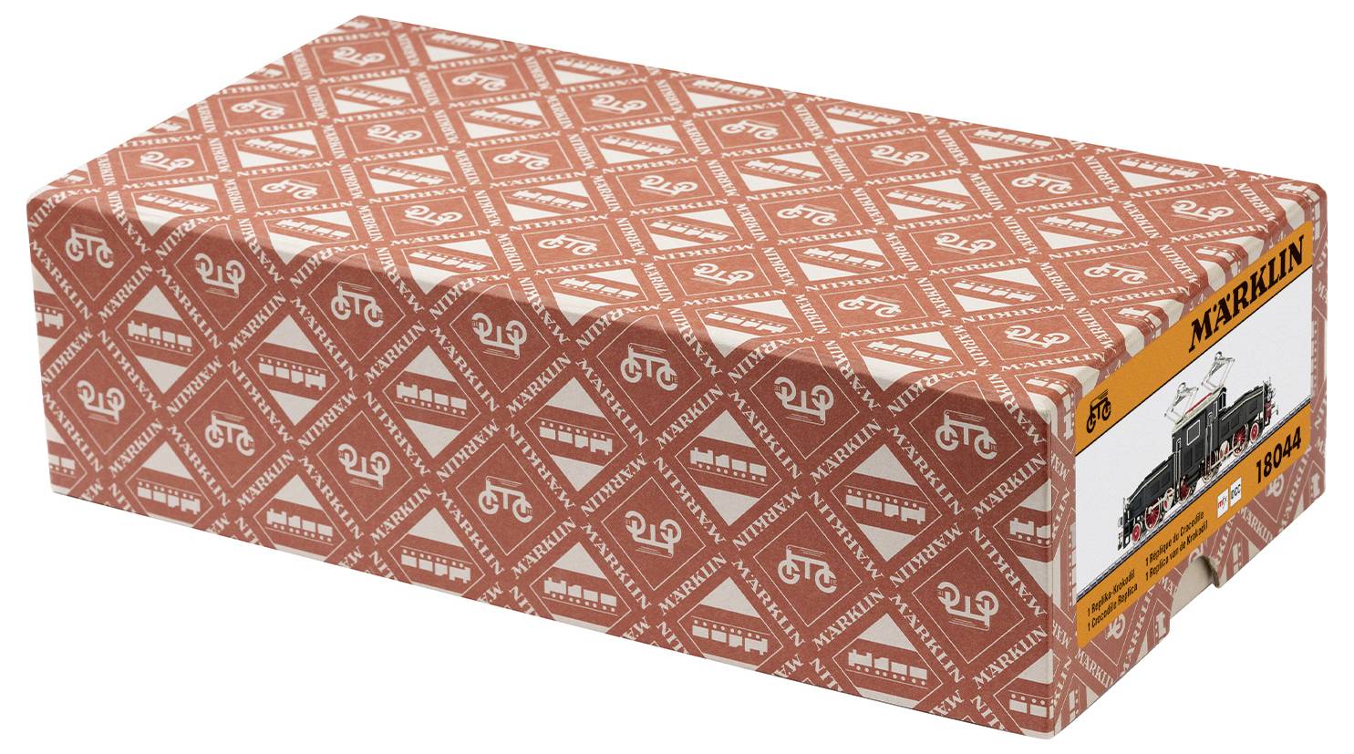 Une boîte de train miniature Märklin, à motif rouge et blanc avec logo, portant une image de la locomotive et le numéro 1894 sur le côté.