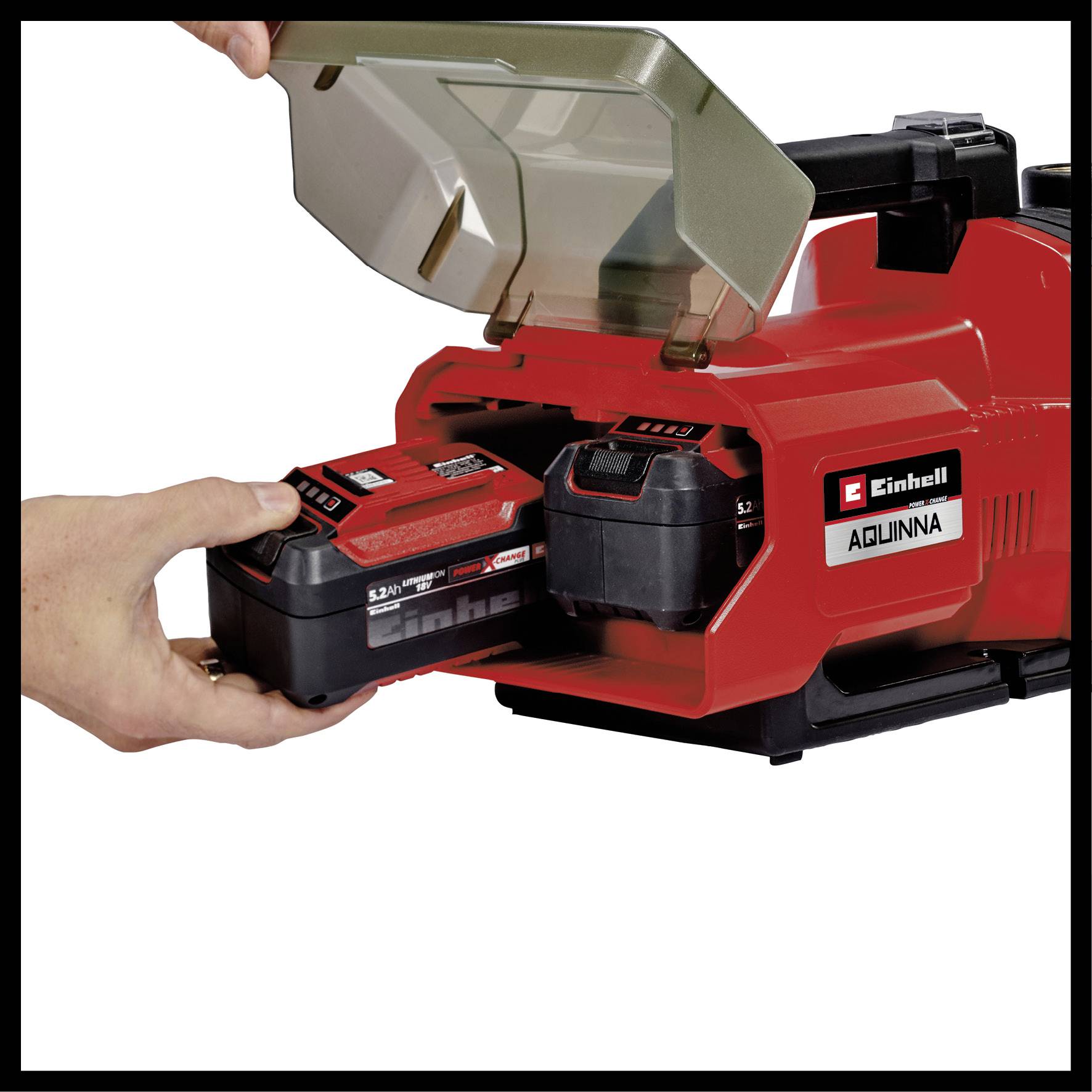 Une meuleuse sans fil rouge de la marque Einhell est ouverte pour changer la batterie. Une main tient une deuxième batterie prête à être installée.