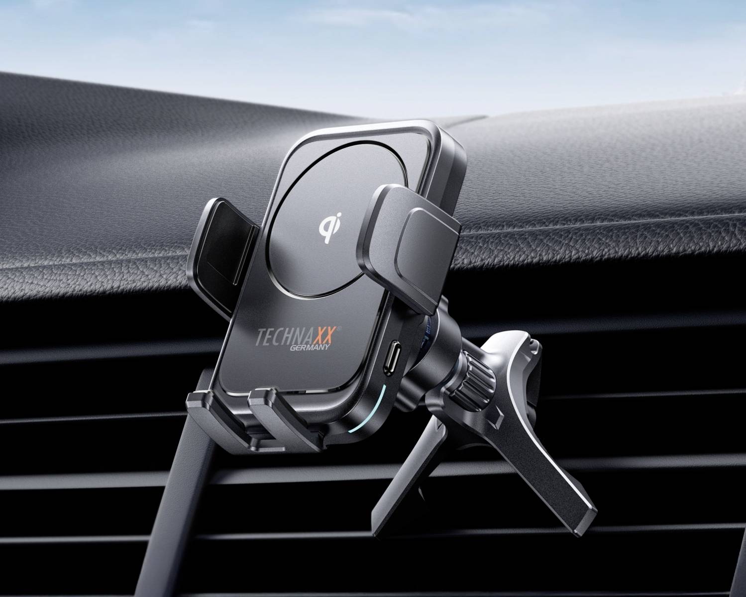 Un support de smartphone universel avec fonction de charge sans fil est fixé à une grille de ventilation dans une voiture.