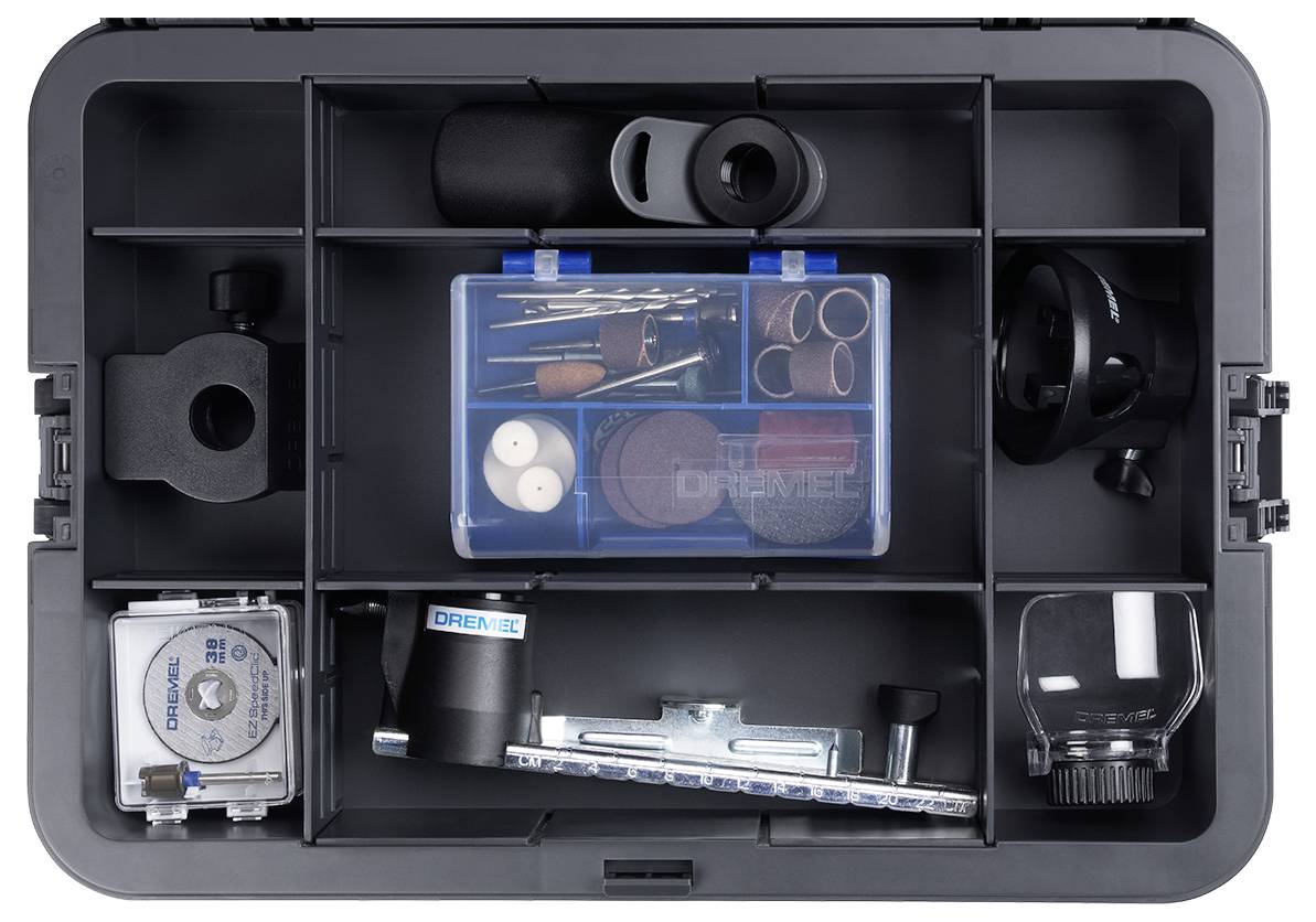 Un coffret à outils ouvert présente divers accessoires et embouts Dremel, soigneusement organisés dans des compartiments.
