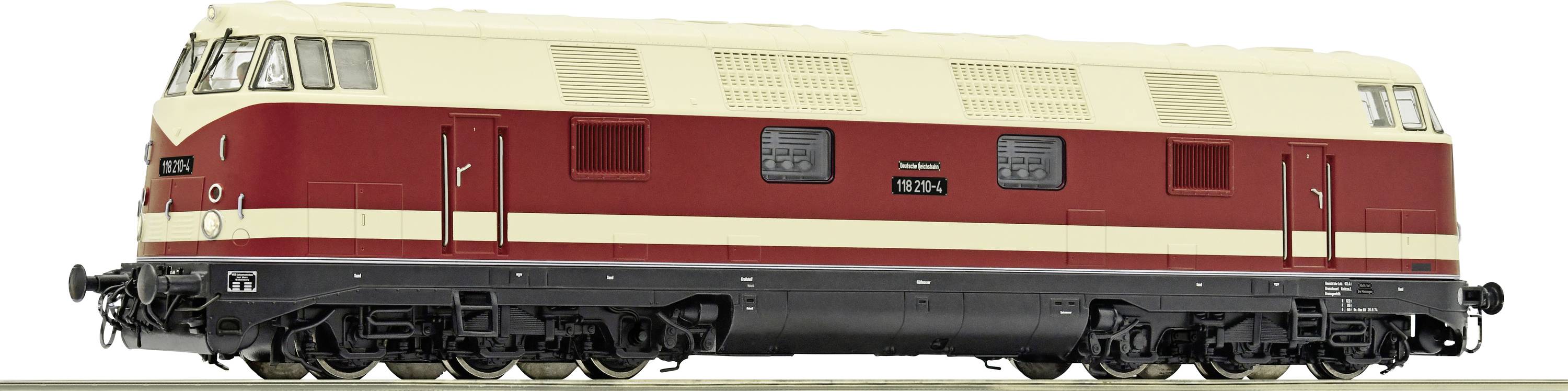 Train miniature : Une locomotive diesel crème-rouge de la série V 180 sur une section de voie, avec des détails des fenêtres et des portes.