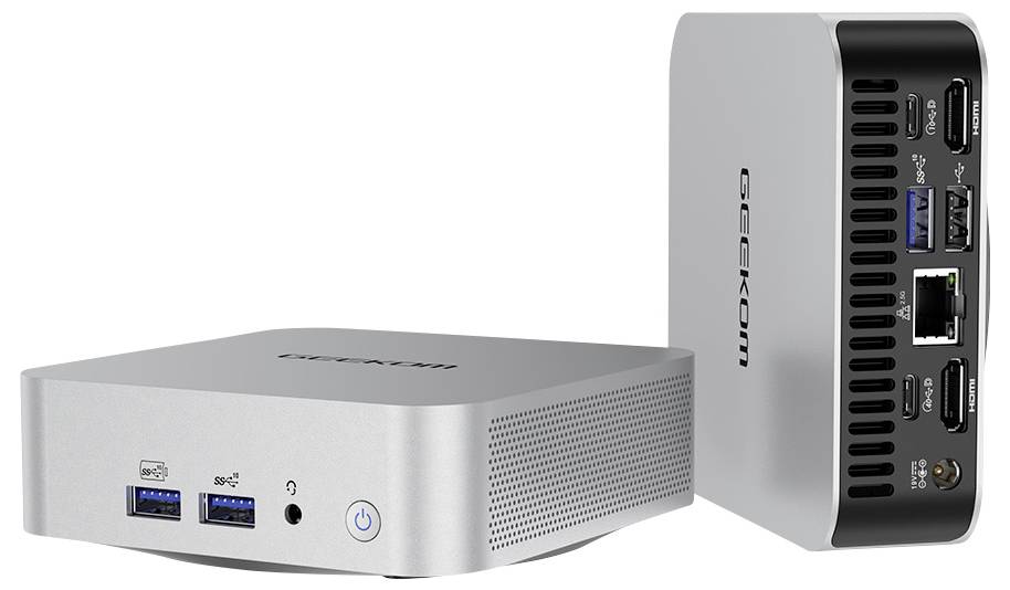 Un ordinateur de bureau compact en argent montre ses faces avant et arrière. À l'avant : ports USB, prise casque, bouton d'alimentation. À l'arrière : divers ports.