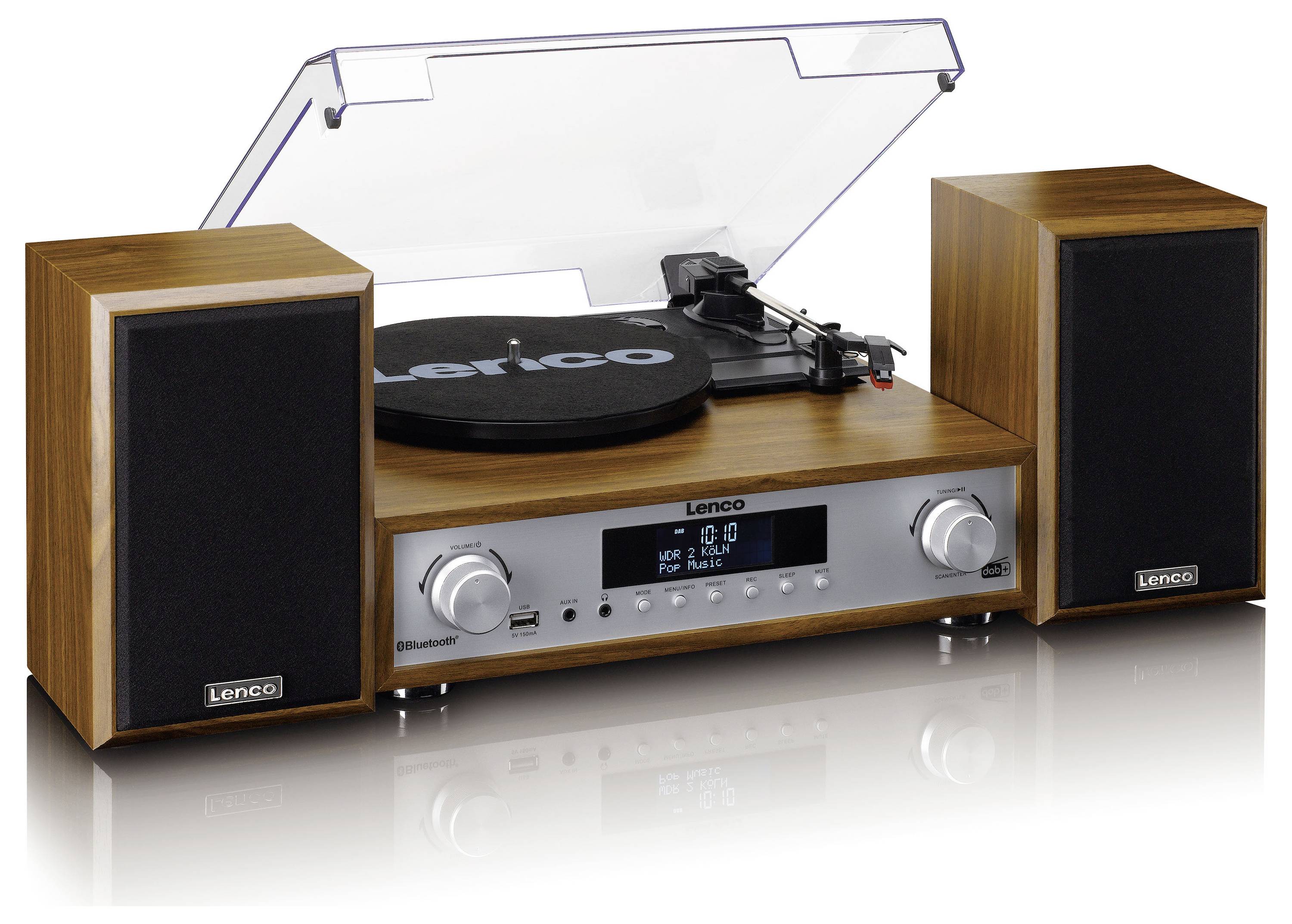 Tourne-disque avec deux enceintes au design bois, plateau de lecture au centre, couvercle anti-poussière transparent. Affichage audio à l'avant.