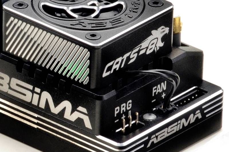 Composant électronique avec ventilateur et texte étiqueté 'CATS-R' et 'ABSIMA' ; montre des connexions pour 'PRG' et 'FAN'.