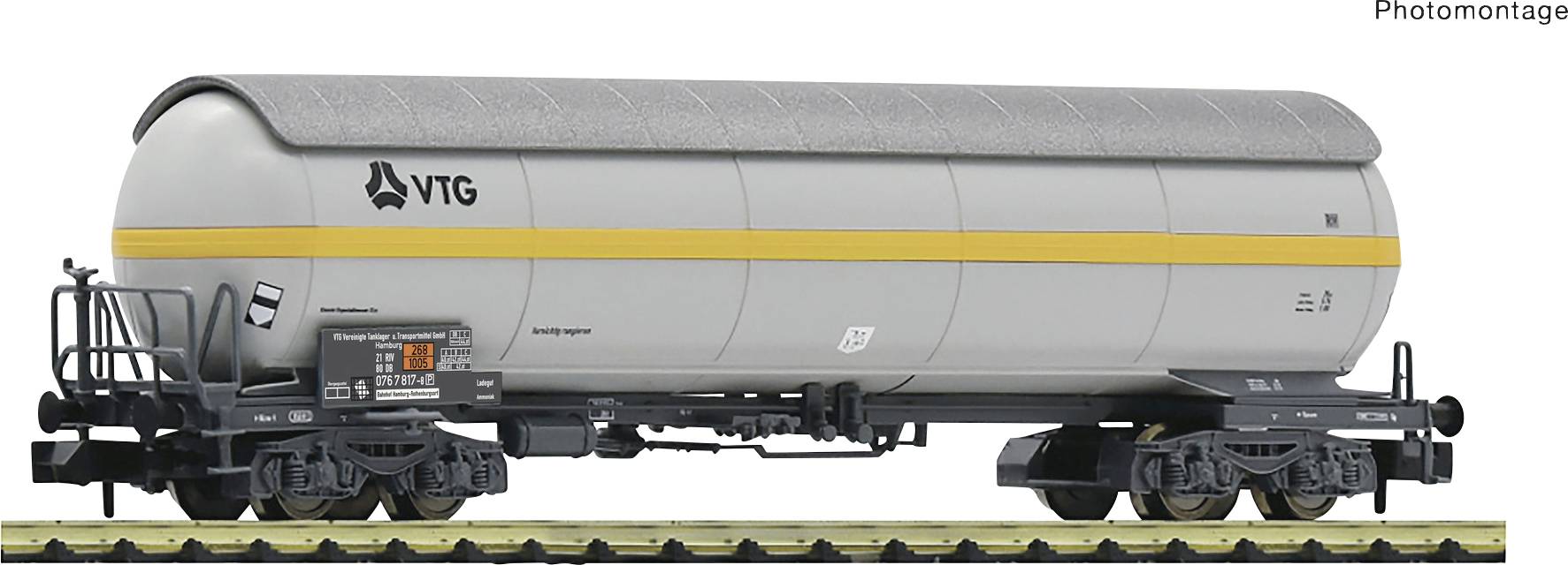 Un wagon-citerne VTG argenté avec une bande jaune est stationné sur une voie ferrée. Le wagon est conçu pour le transport de liquides.