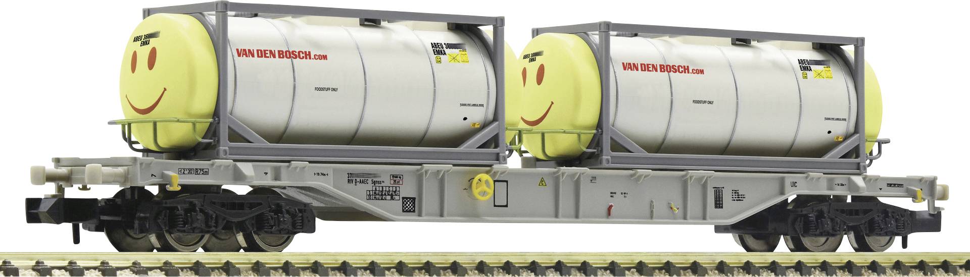 Deux wagons-citernes avec des visages souriants sur un wagon de chemin de fer, portant l'inscription 'VAN DEN BOSCH'. Ils sont garés sur des rails.