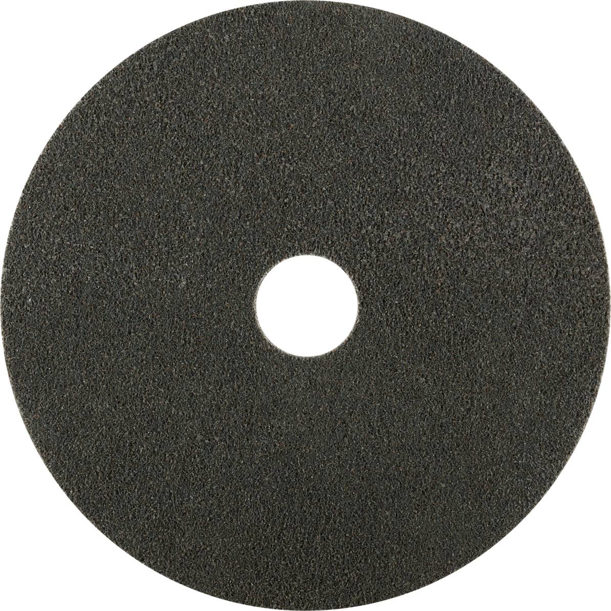 Un disque abrasif rond en matériau grossier gris foncé, avec un trou central, adapté aux travaux sur métal ou sur bois.
