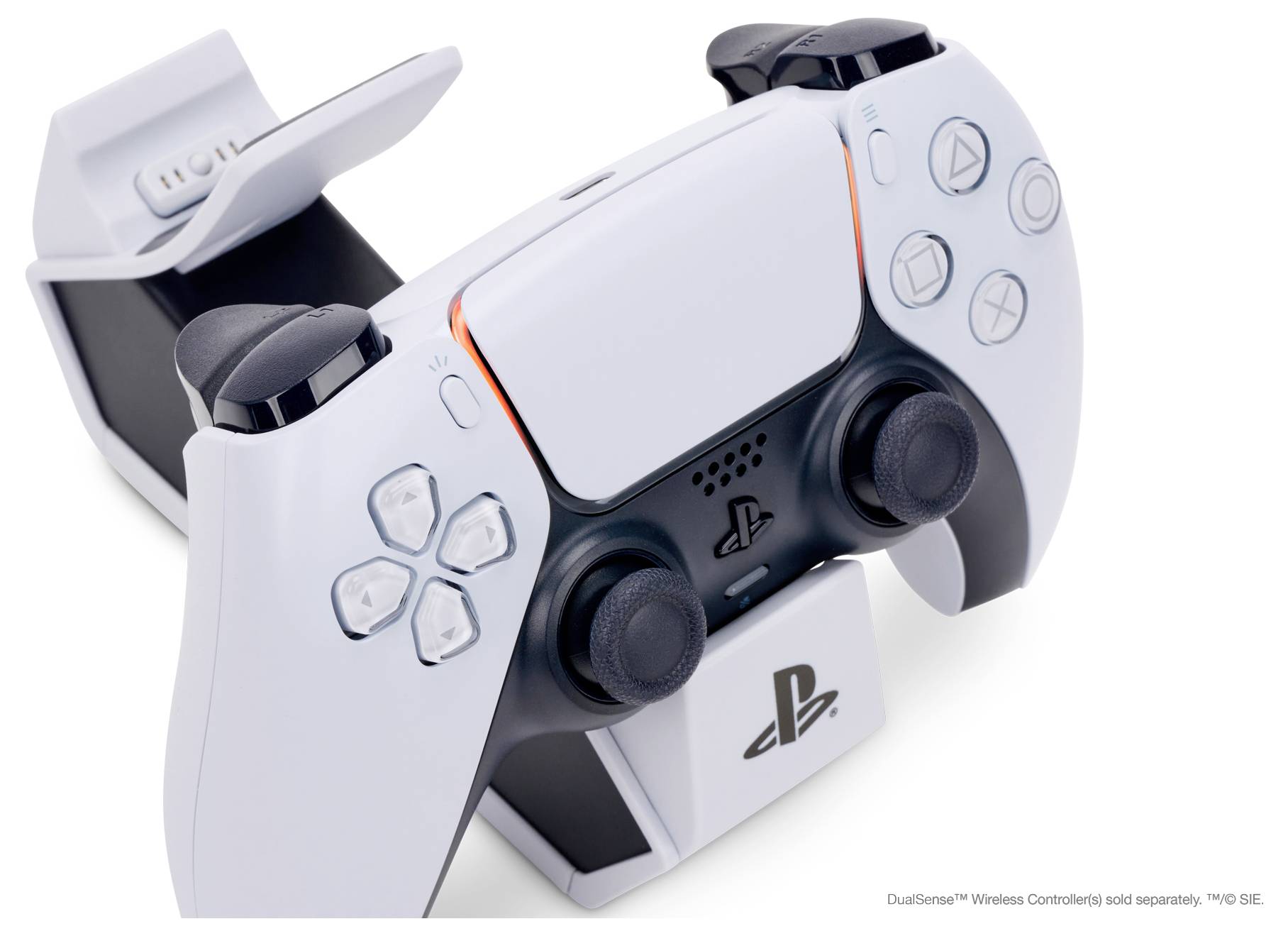 Une manette blanche est placée dans sa station de charge. La manette présente des poignées ergonomiques et arbore le logo PlayStation.