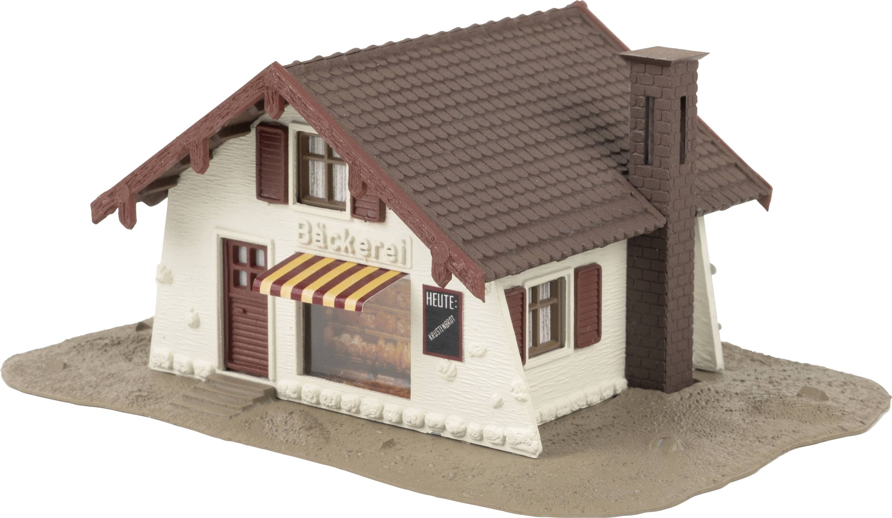 Un modèle d'un petit bâtiment portant l'inscription 'Boulangerie' et un panneau 'Aujourd'hui' à côté d'un volet rouge.