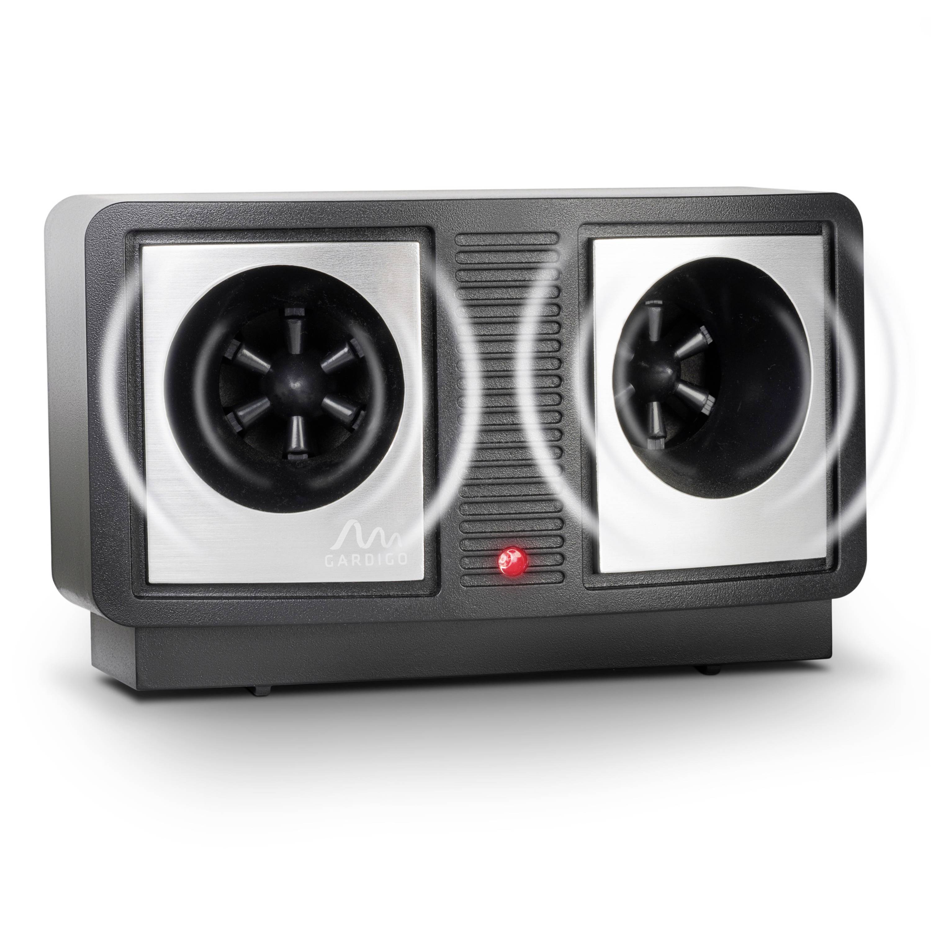 Un appareil avec deux haut-parleurs émettant des sons ultrasonores pour repousser les nuisibles. Au premier plan, on peut voir des ondes sonores.