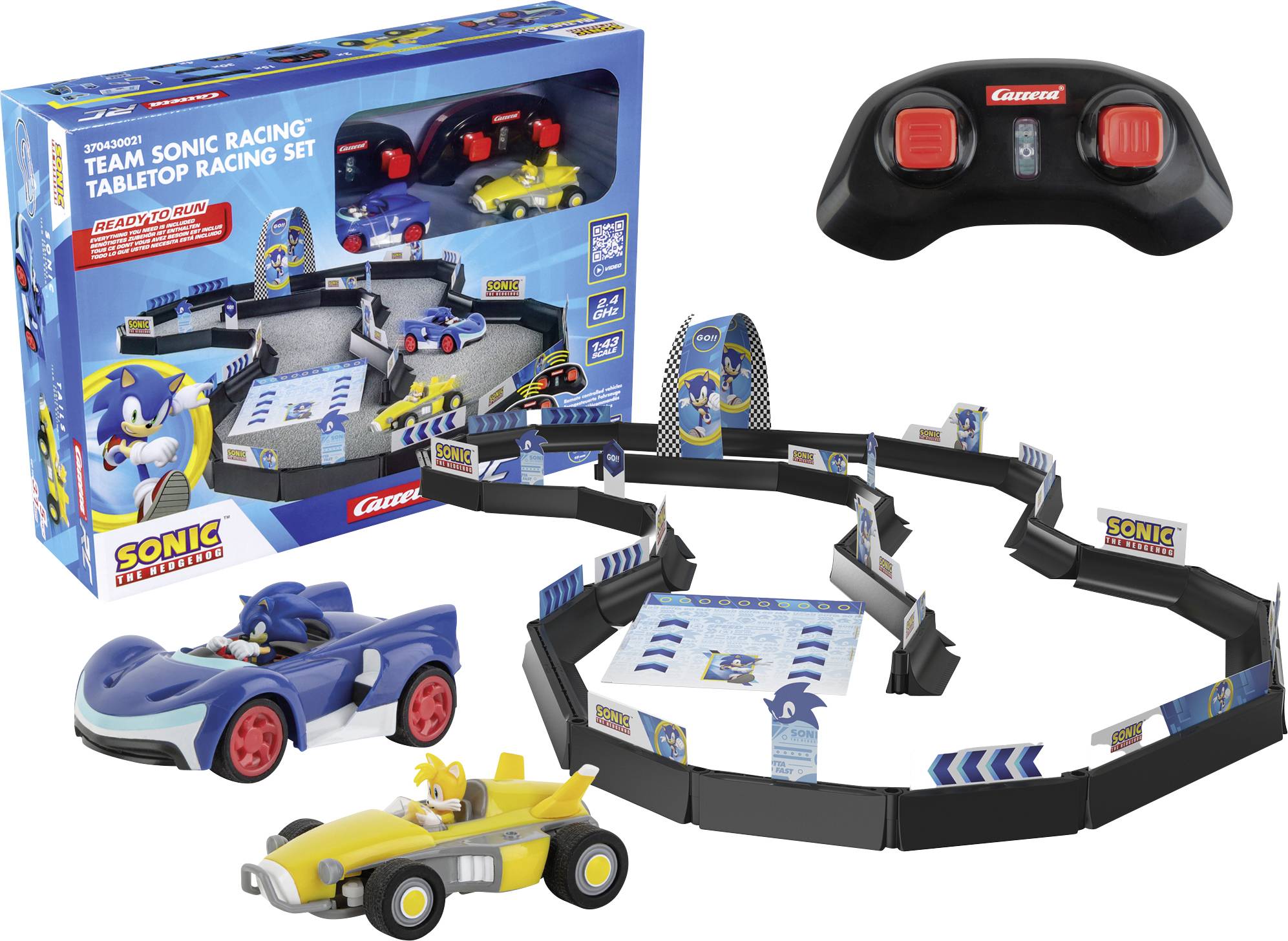 Un ensemble de course de table 'Team Sonic Racing', comprenant deux petites voitures de course et une manette. Inclut une piste de course incurvée.