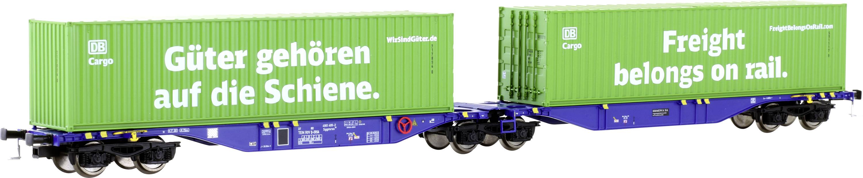 Deux conteneurs verts sur des wagons de chemin de fer avec les inscriptions « Les marchandises appartiennent au rail » et « Freight belongs on rail ».