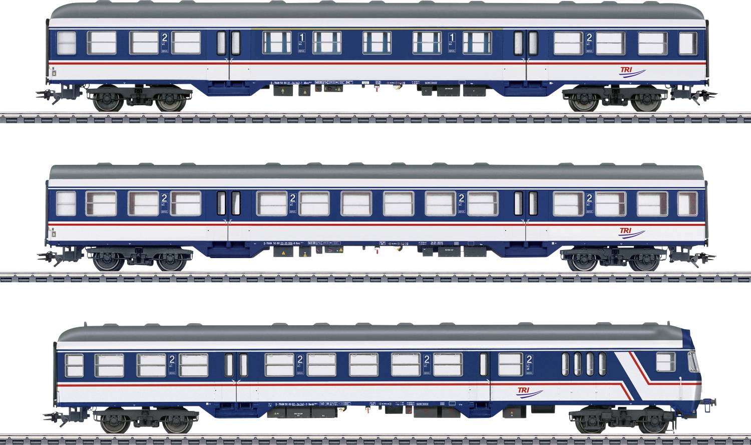 Trois voitures de voyageurs de train miniature sur des rails, peintes en bleu et blanc avec des bandes rouges, vues de côté.