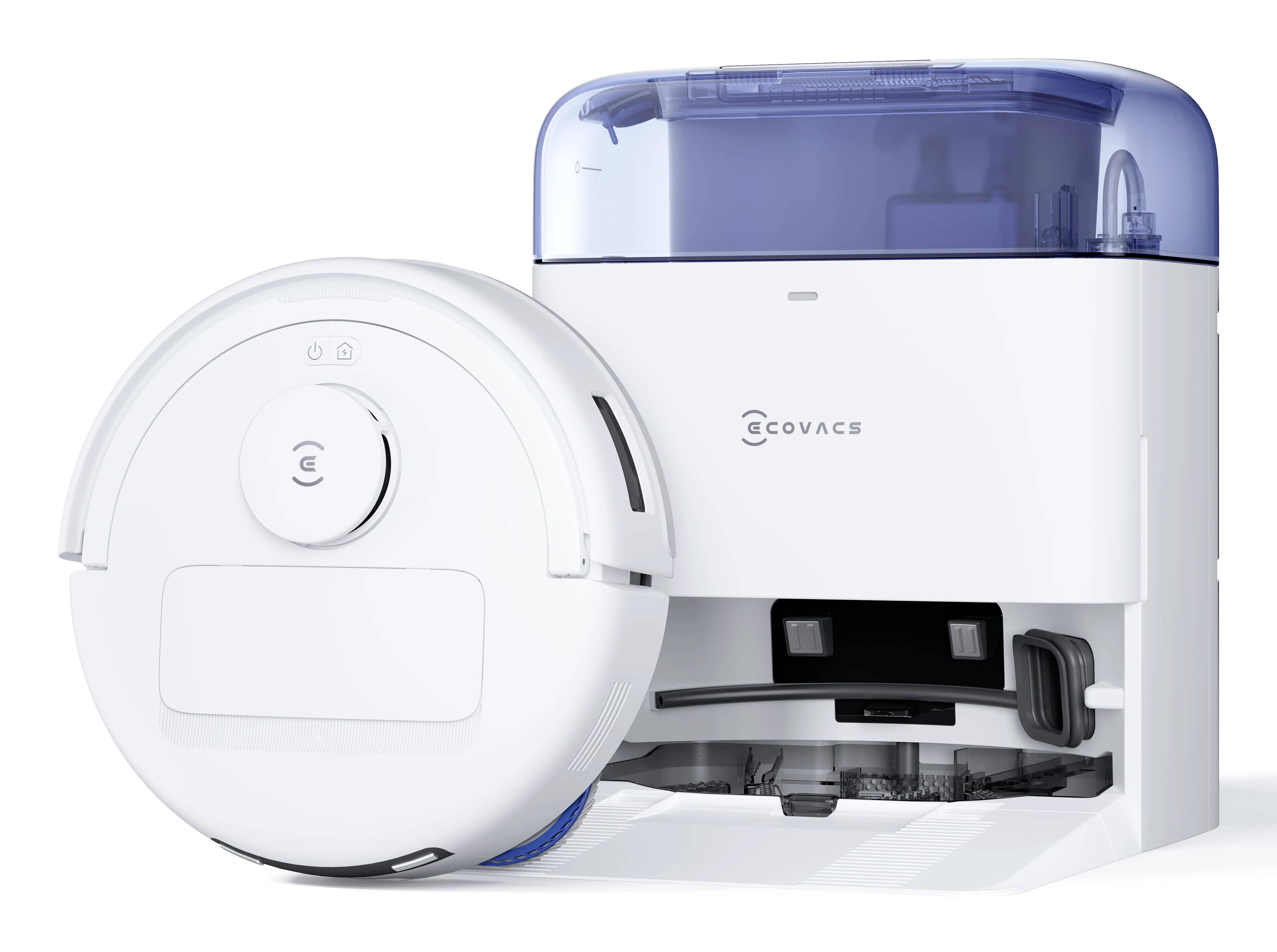 Un aspirateur robot blanc à côté de sa station de recharge. L'aspirateur est conçu pour le nettoyage automatique des sols, avec un design épuré et moderne.