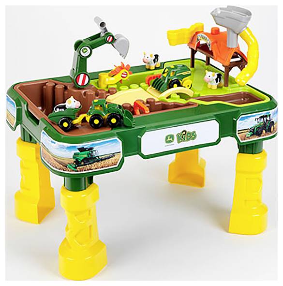 Une table de jeu colorée pour enfants représentant une scène de ferme avec des animaux, des véhicules et des éléments interactifs qui stimulent l'imagination.