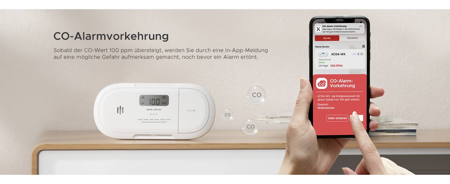 Une personne tient un smartphone affichant l'application 'Mesures d'alerte CO', à côté d'un détecteur de monoxyde de carbone posé sur une étagère.
