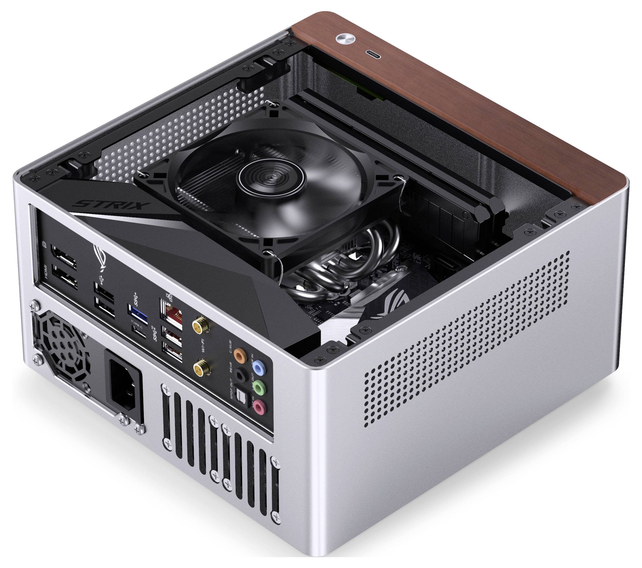 Vue ouverte d'un ordinateur de jeu compact mettant en évidence les composants internes, incluant un ventilateur de refroidissement, des connecteurs d'alimentation et des ports USB.