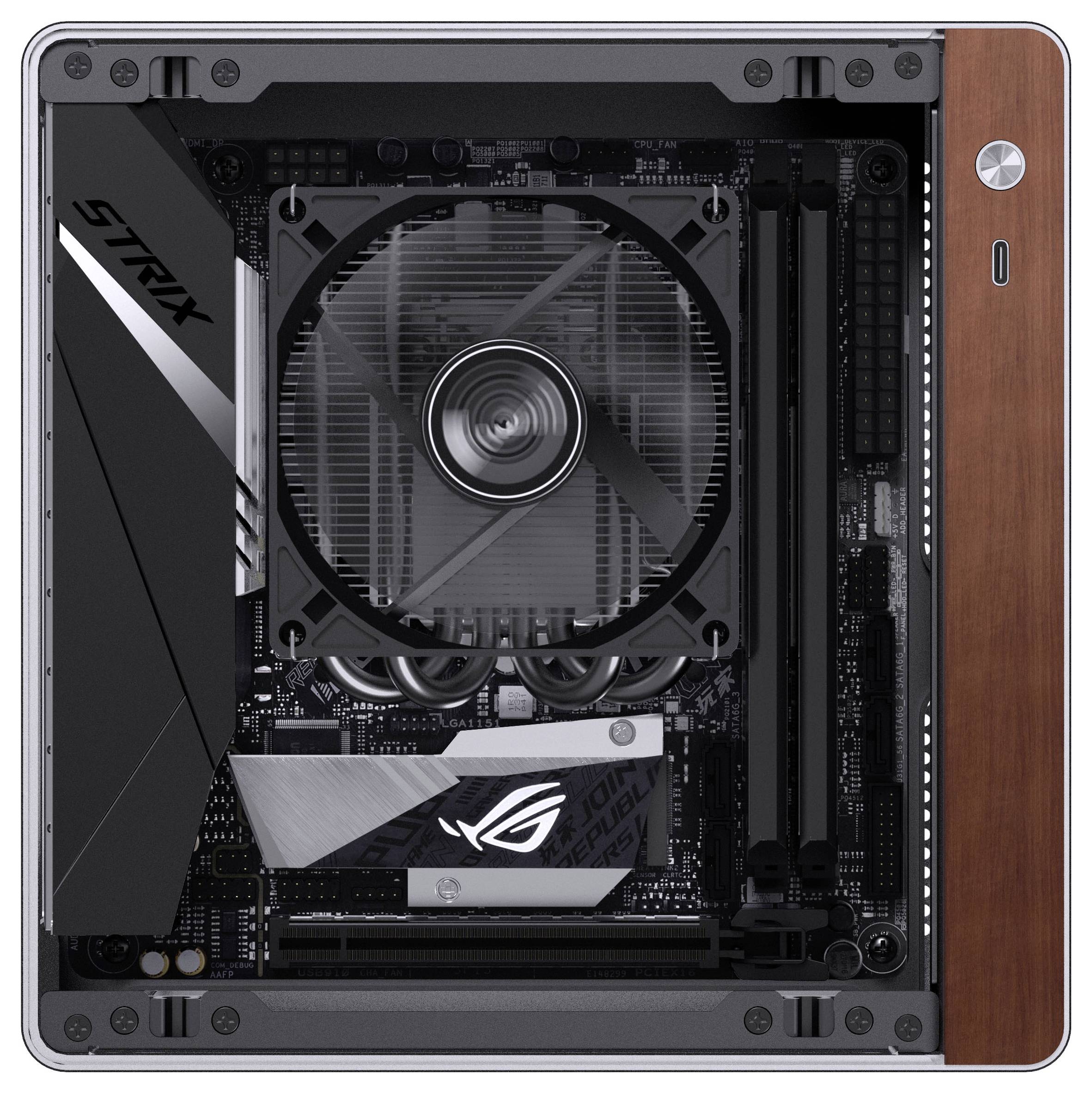 Vue de l'intérieur d'un boîtier d'ordinateur gaming présentant une carte mère avec un grand ventilateur et des emplacements de RAM visibles, mettant en valeur son design compact.