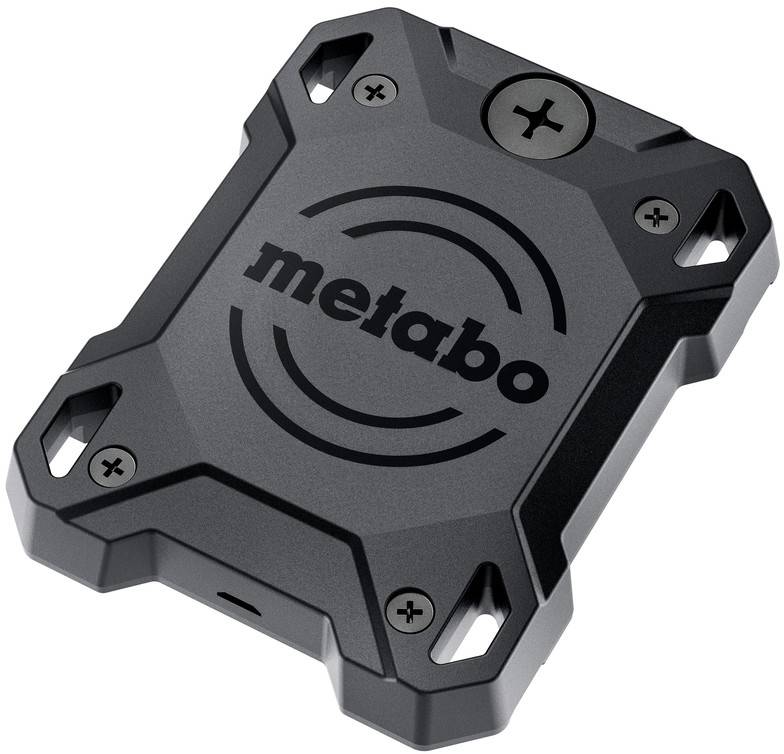 Une batterie Metabo noire et grise vue d'un angle supérieur, présentant un design robuste et compact avec un logo circulaire sur le dessus.