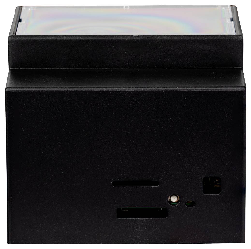 Un petit appareil électronique noir avec des fentes et des ports sur un côté, probablement destiné à l'utilisation de supports numériques. Sa surface supérieure est réfléchissante.