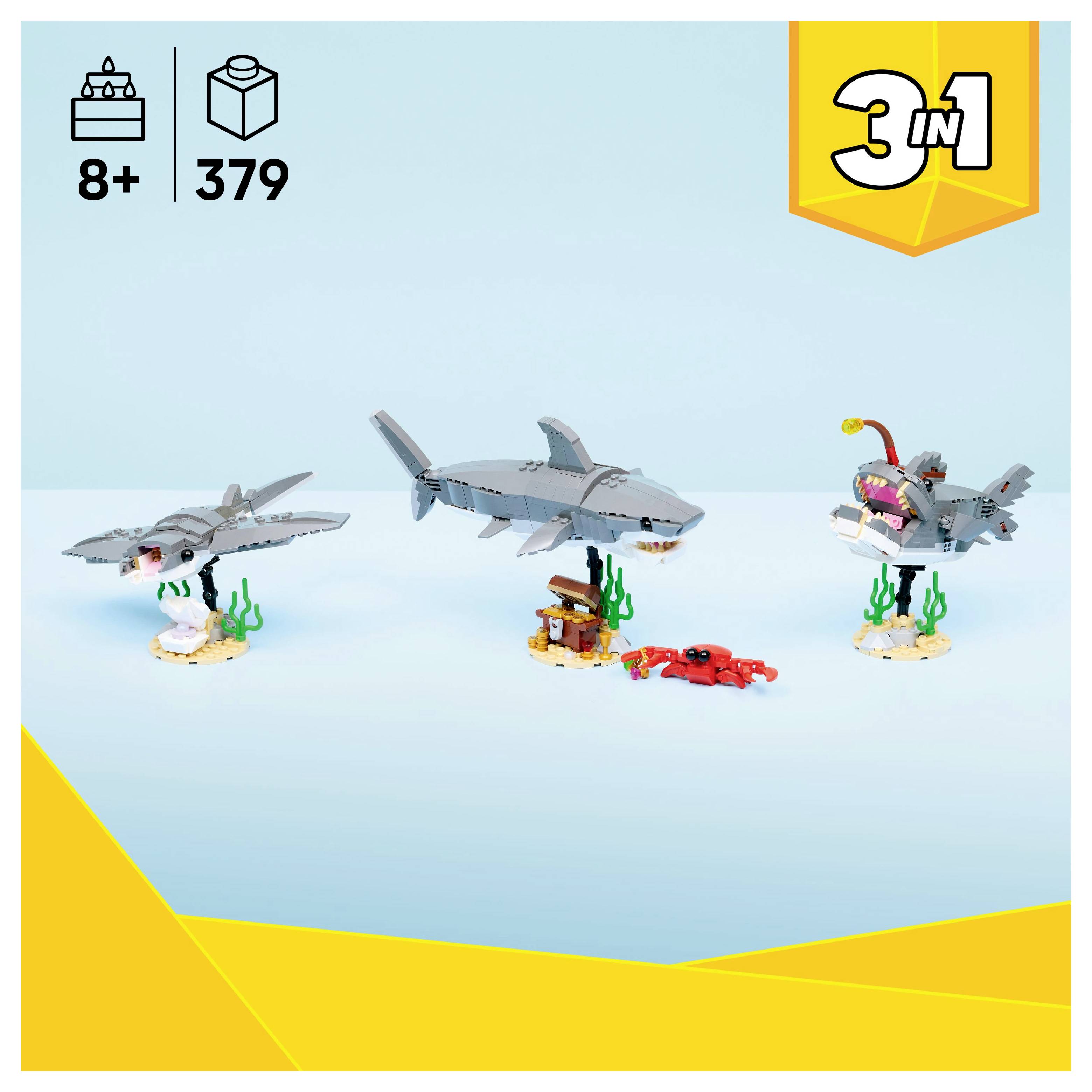 Ensemble de construction de jouets avec trois modèles de requins et scène sous-marine. Comprend diverses pièces pour un assemblage créatif. Âge 8+, 379 pièces.