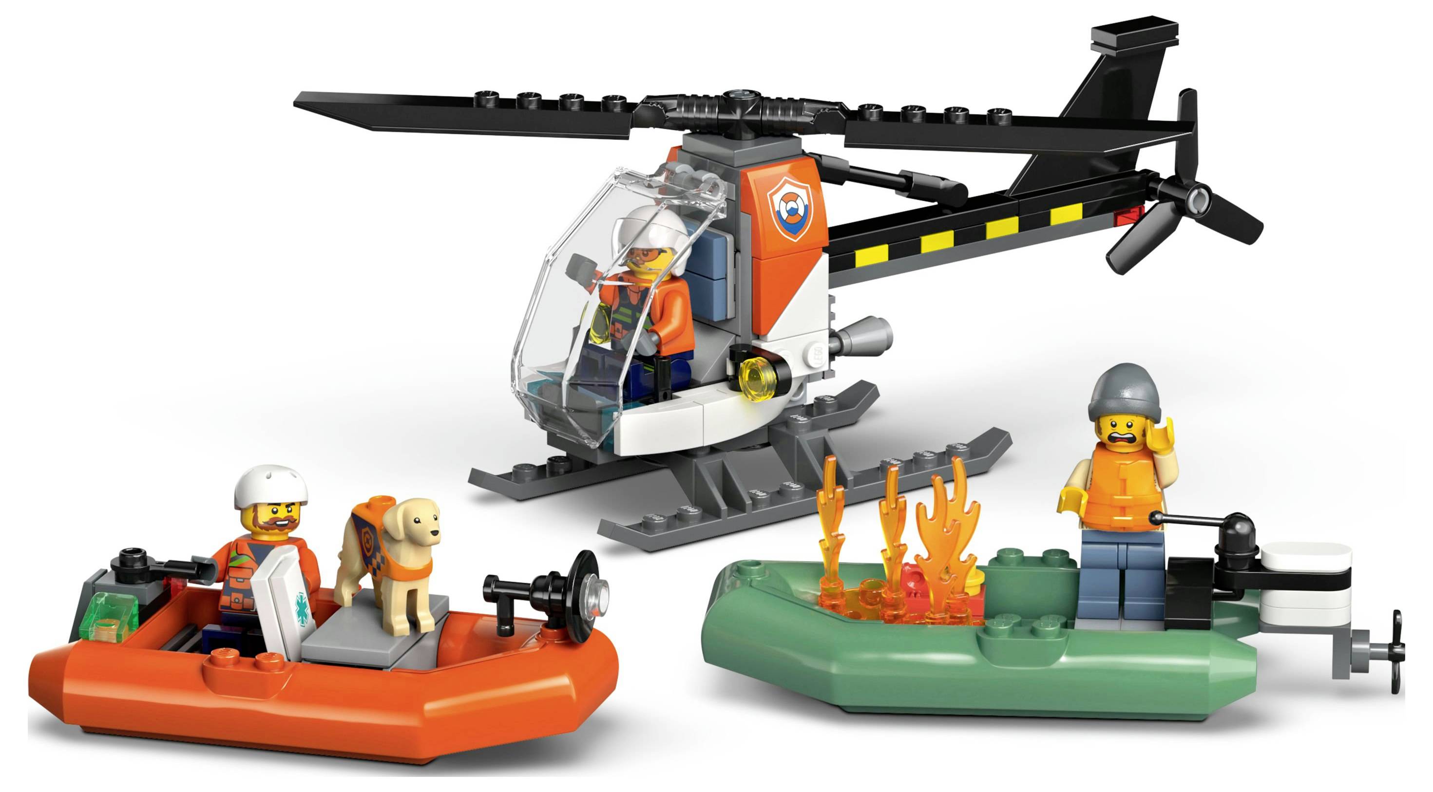 « Un hélicoptère jouet et deux bateaux avec des figurines, comprenant un travailleur de secours, un chien et des flammes dans une scène de sauvetage ludique. »